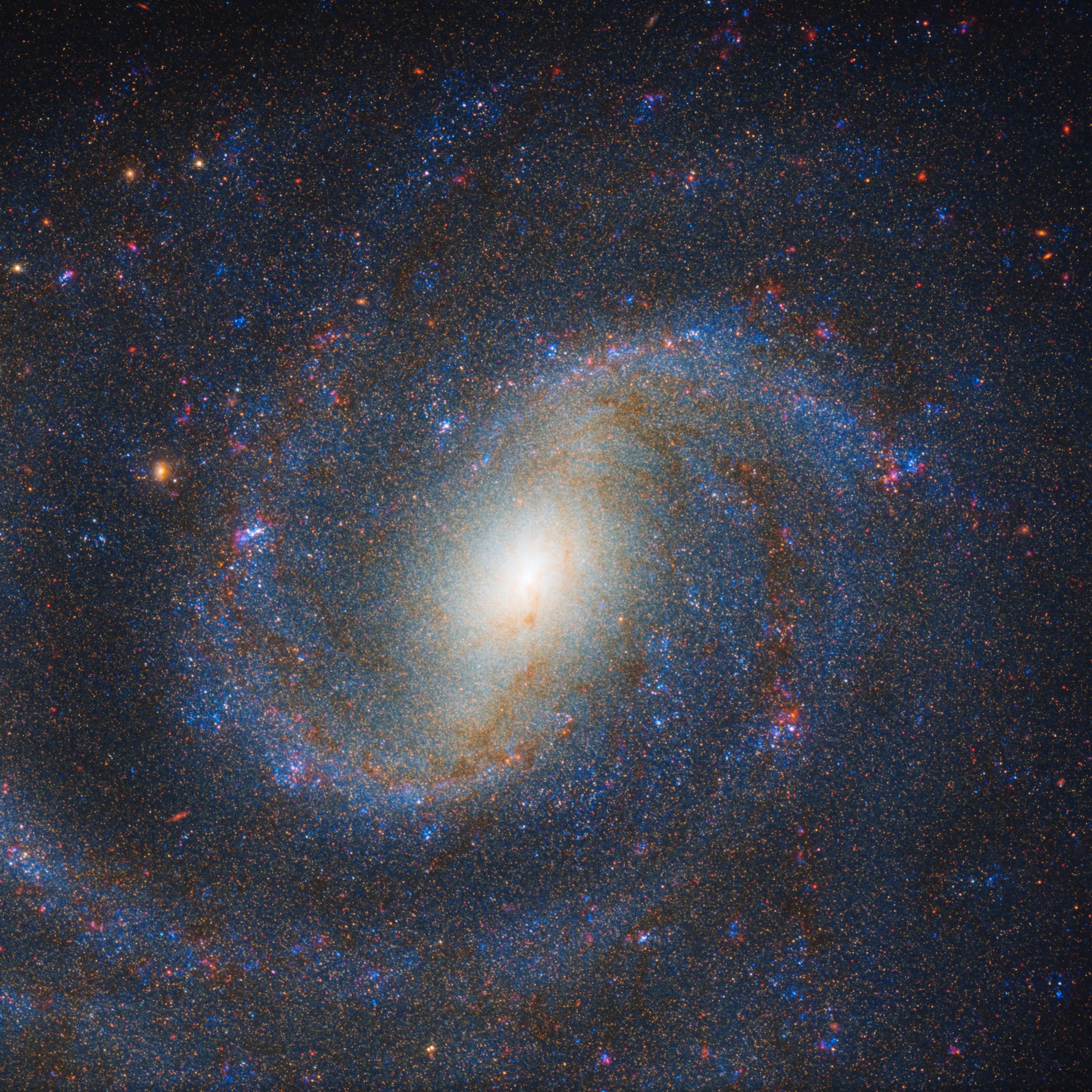A vibrant spiral galaxy, glowing center, swirling blue and red stars set against a dark background.