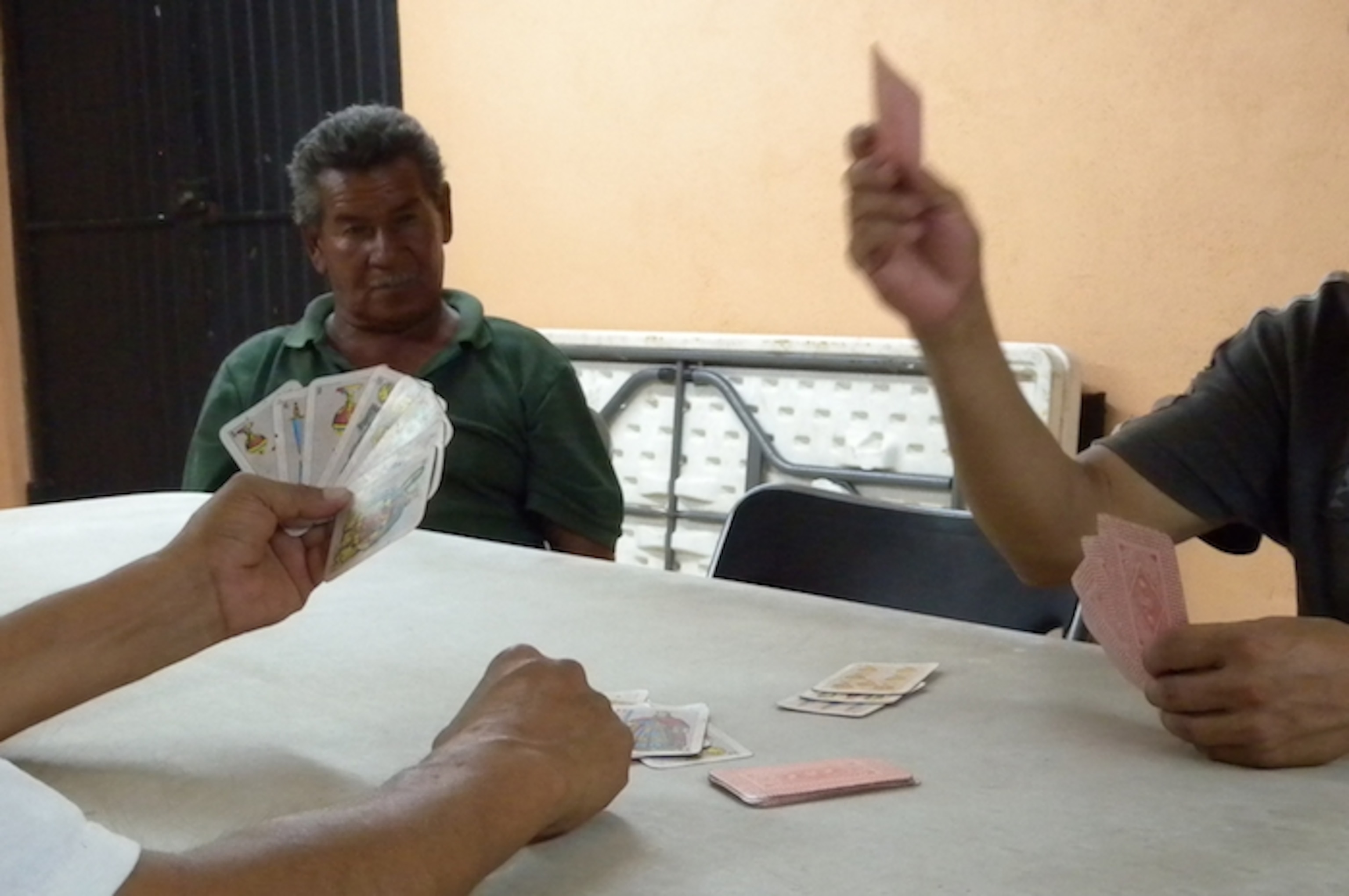 Miguel and Victor play poker at a migrants' shelter in Nogales, Mexico. Photo by Jason De León.