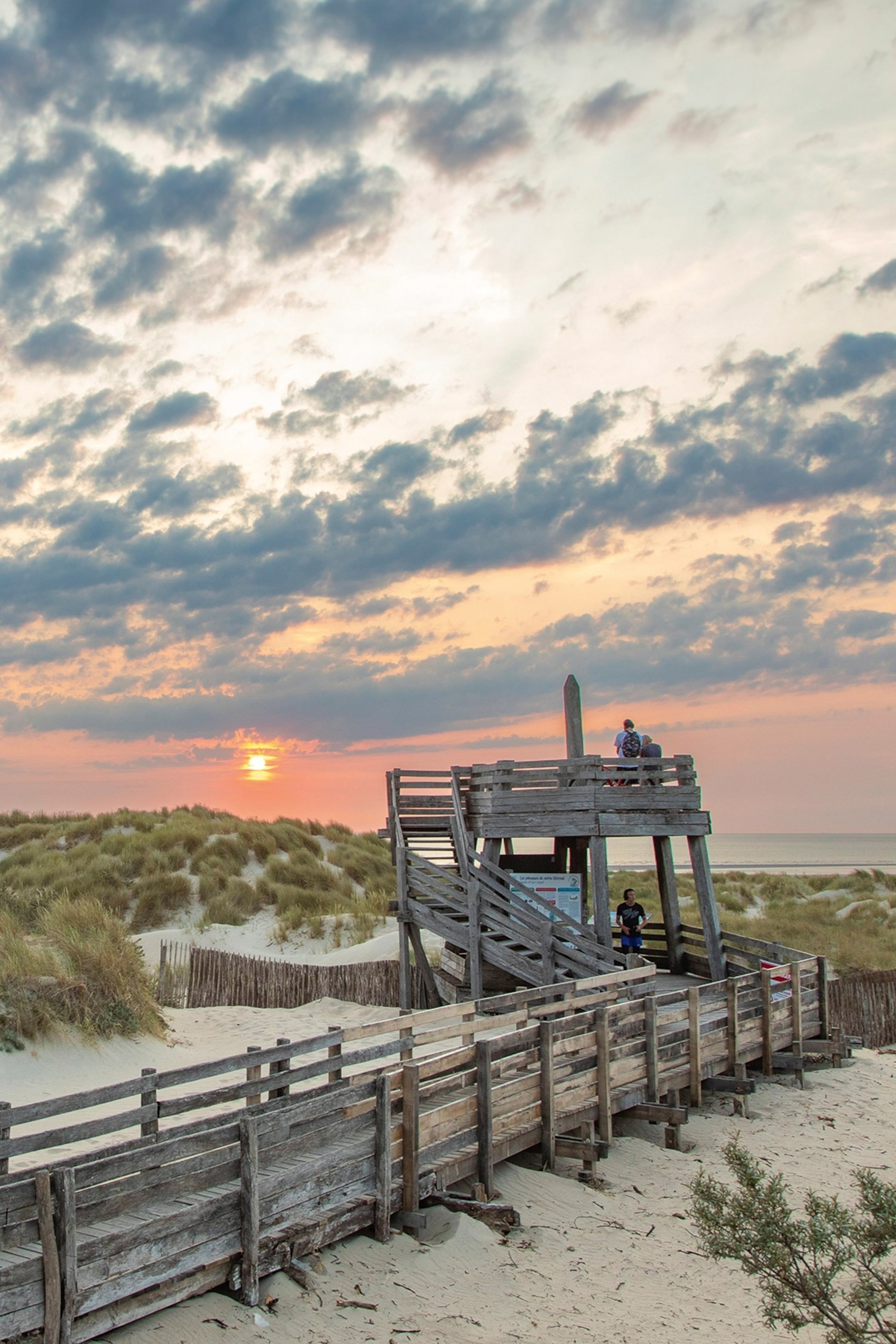 An observatory deck on a beach in France at early sunset.