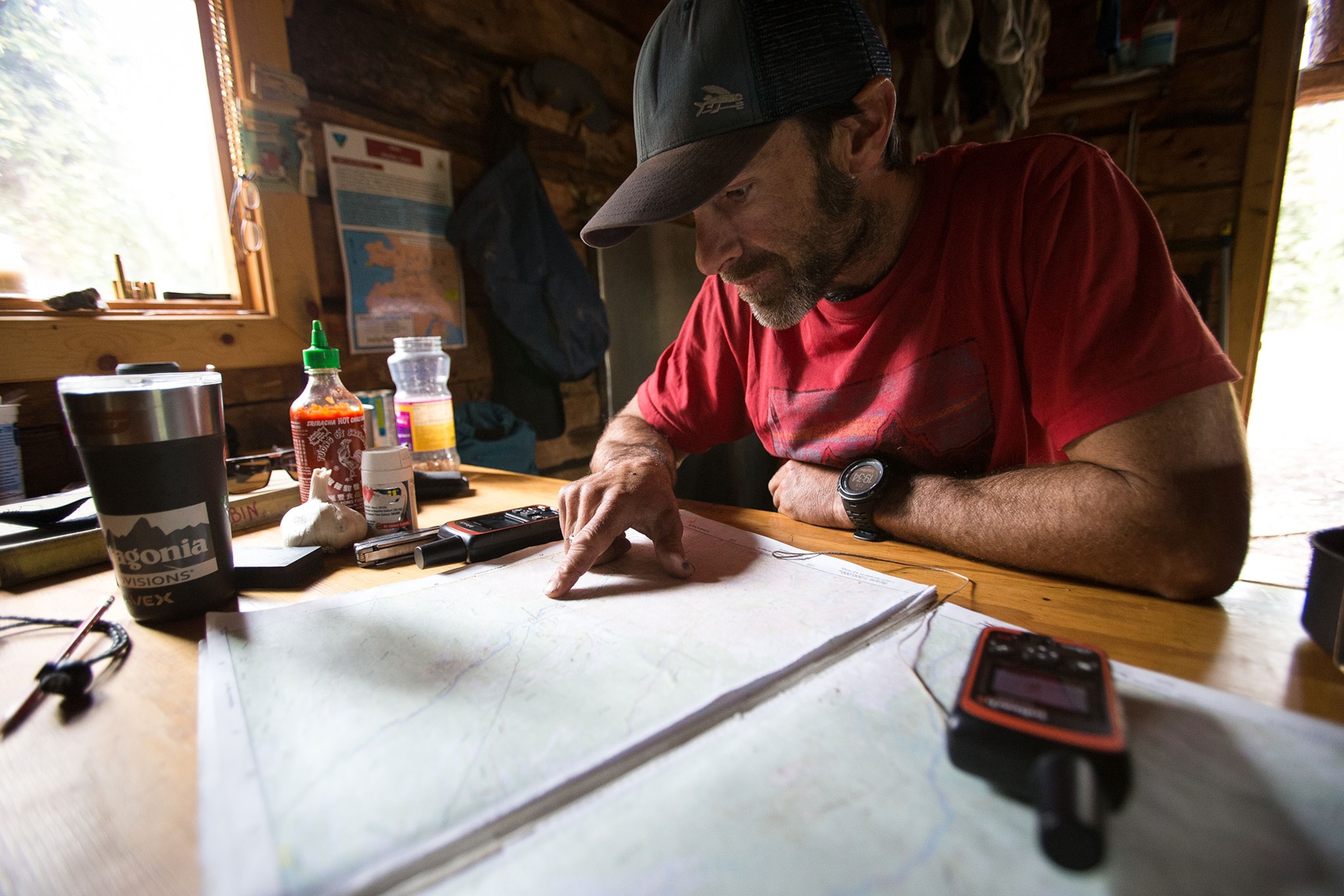 Gavin McClurg studying maps while during the Alaska paraglding traverse