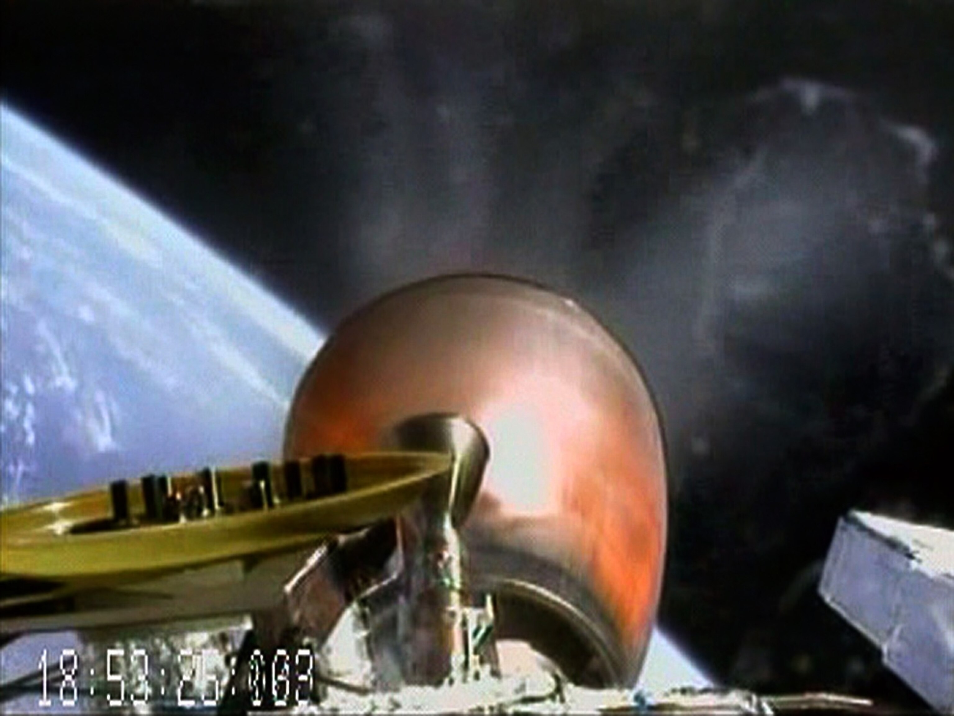 A picture from an onboard camera shows the engine nozzle of the Falcon 9 launch vehicle, in orbit above Earth.