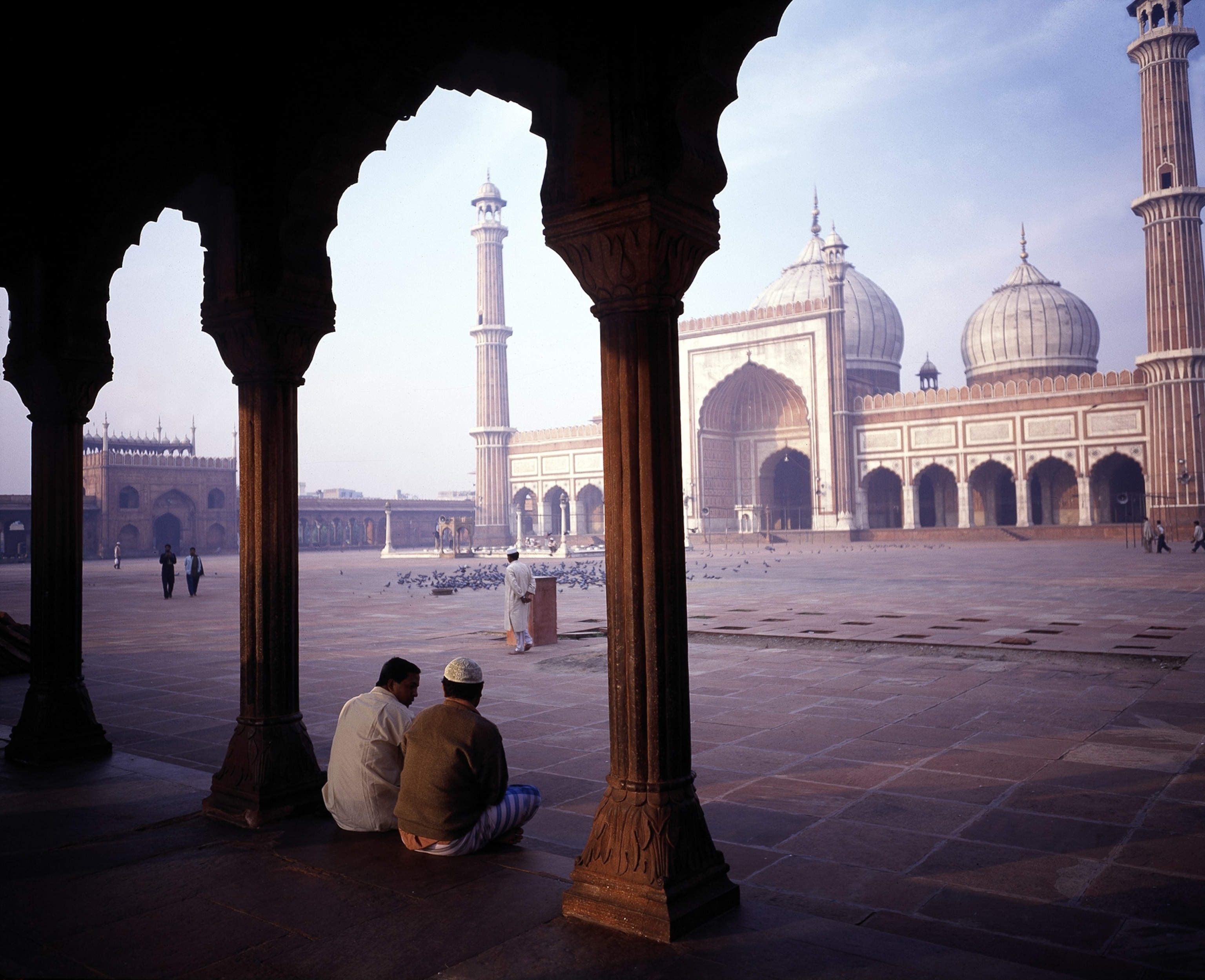 2 men sitting at a mosque