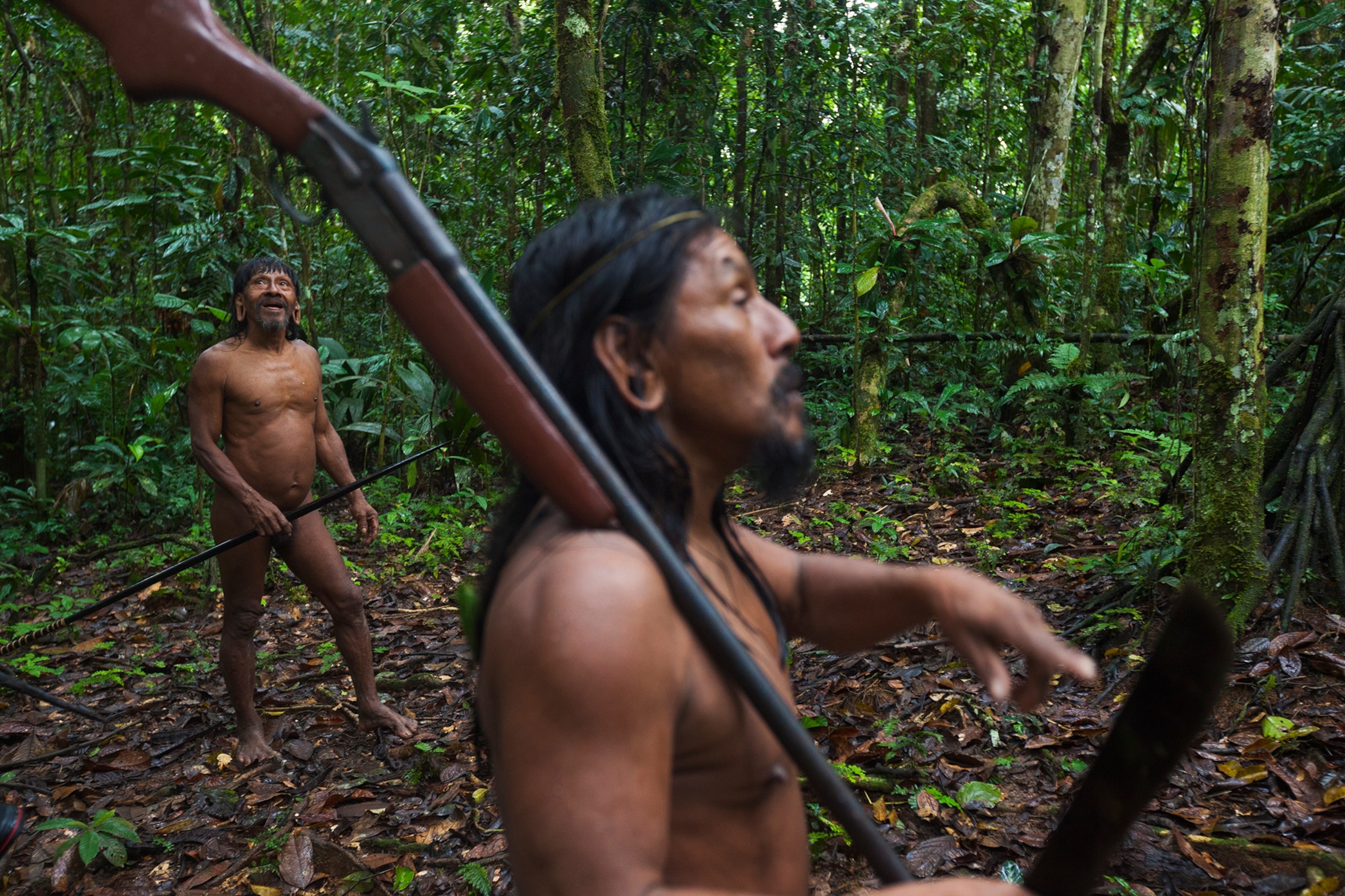 Armed with spear, shotgun, and machete, Minihua Huani (at left) and Omayuhue Baihua search for animals near the Waorani community of Boanamo. Villagers are allowed to hunt in the park, their ancestral territory. Many still do, to provide food for their families.