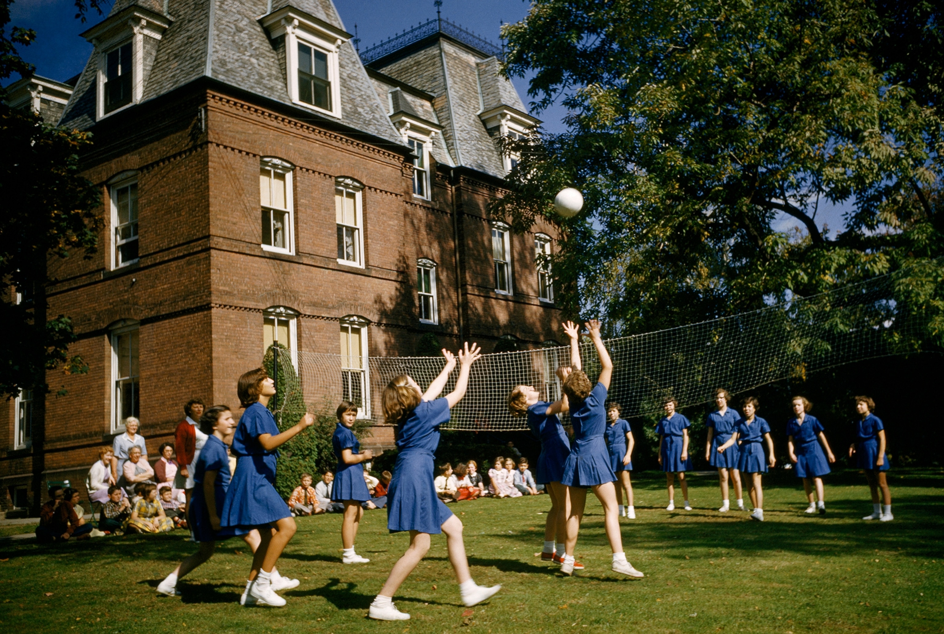 Female students play volleyball outside Gawith Hall.