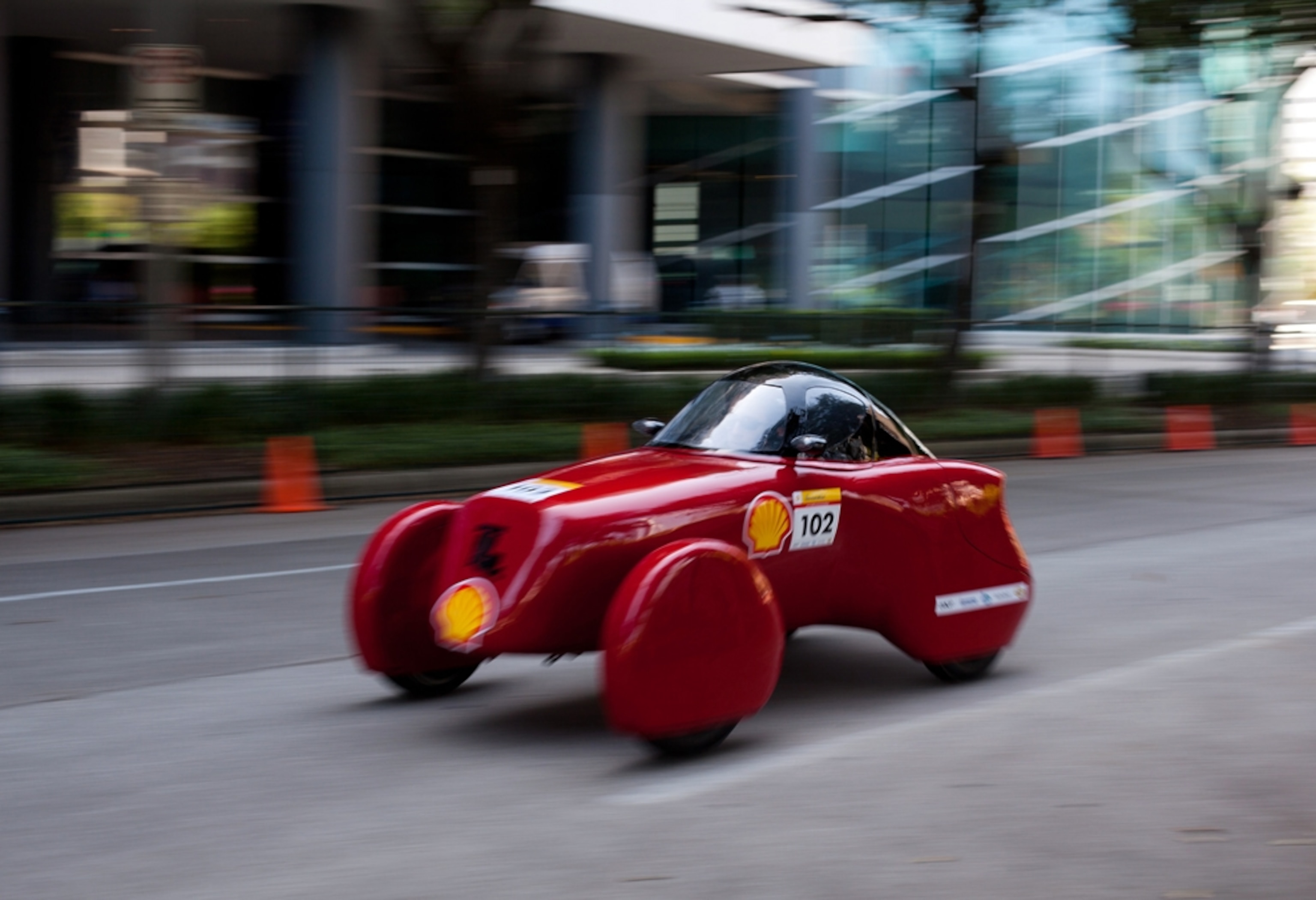 Tiny red vehicle designed to look like a classic roadster
