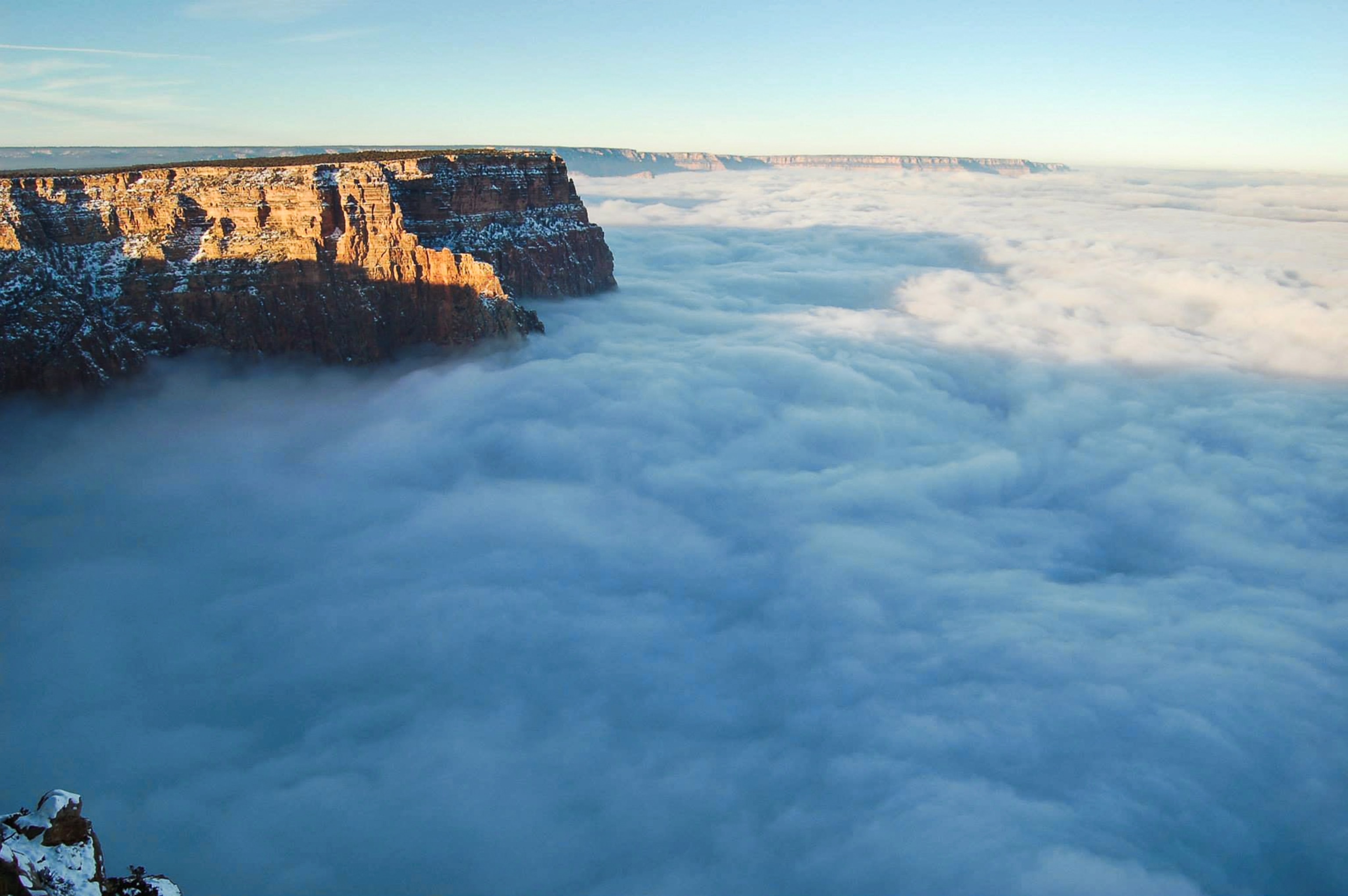 the Grand Canyon peaking above a sea of clouds.