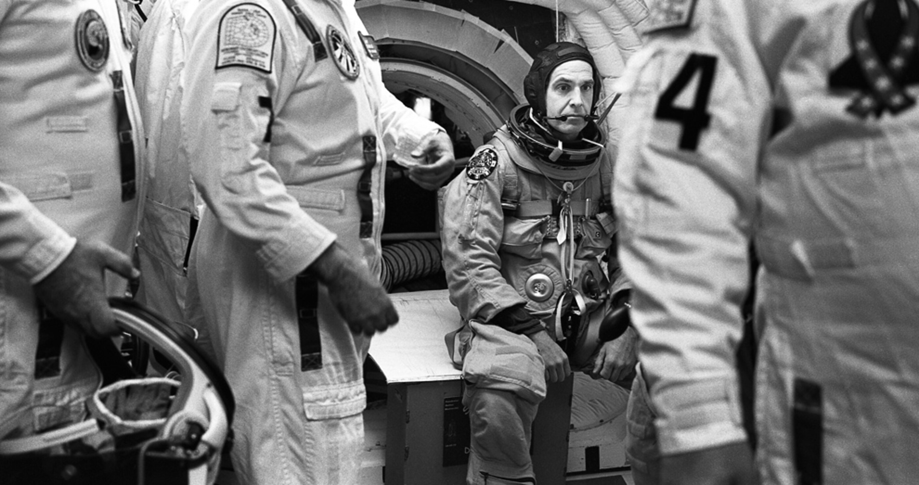an astronaut and support crew during a prelaunch practice run