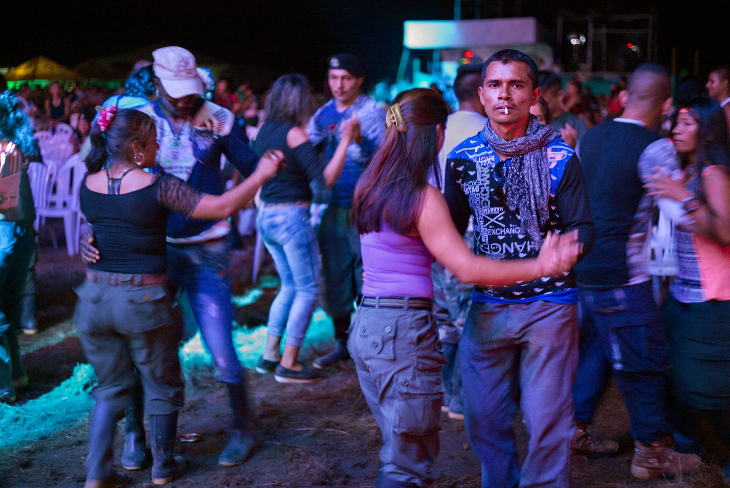 couples dancing in blue light outside at night