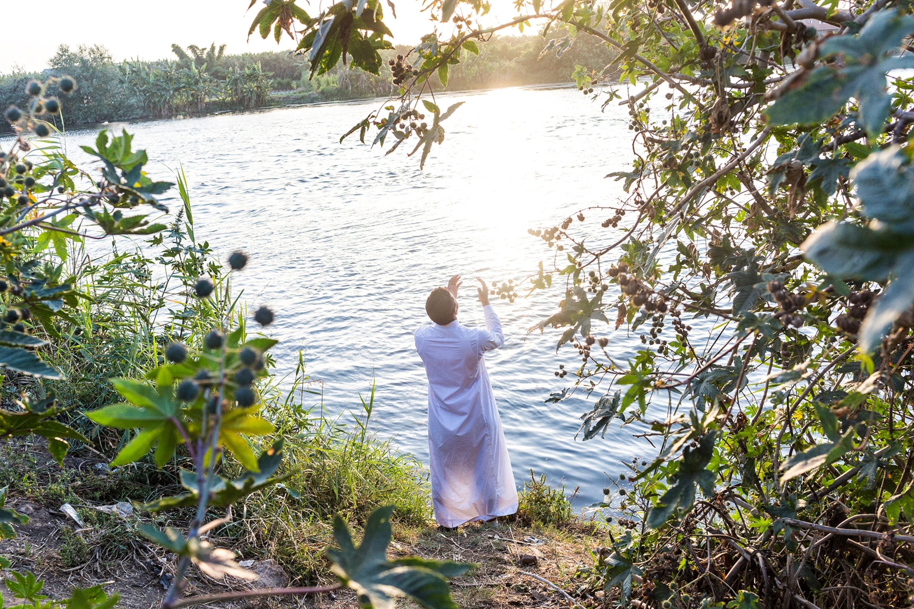 man praying by nile river