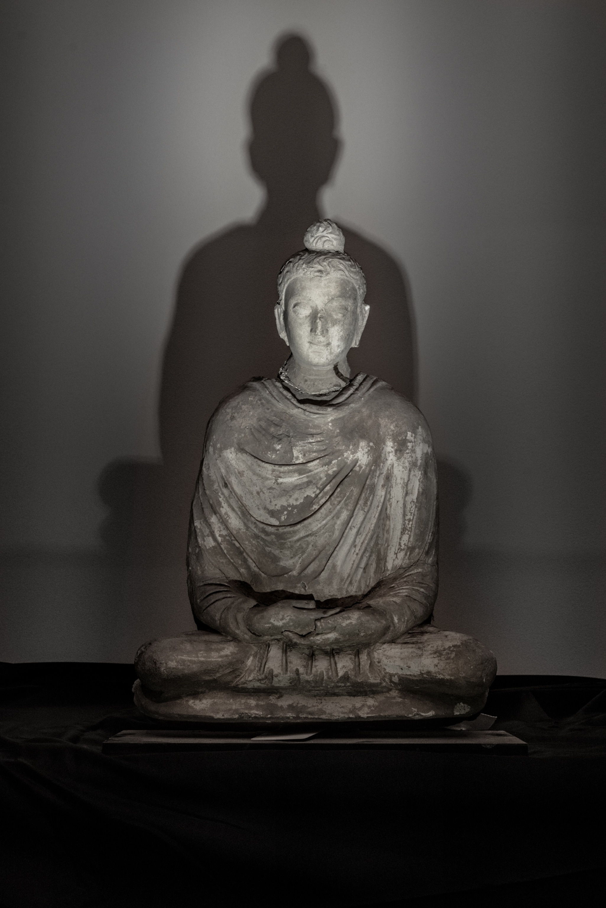 Statue of the Buddha lit by the camera flash