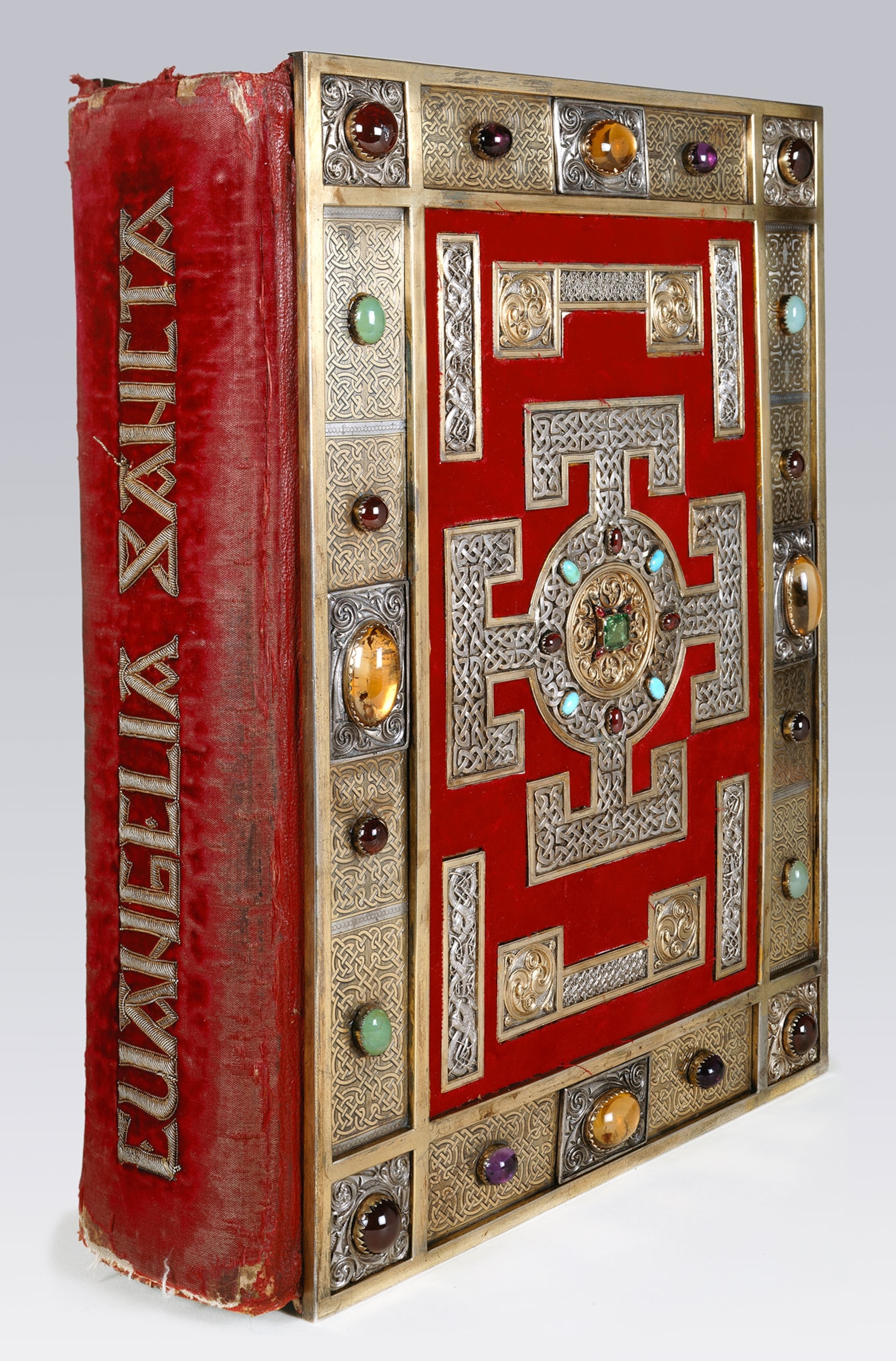 A book with gold details and colorful stones.