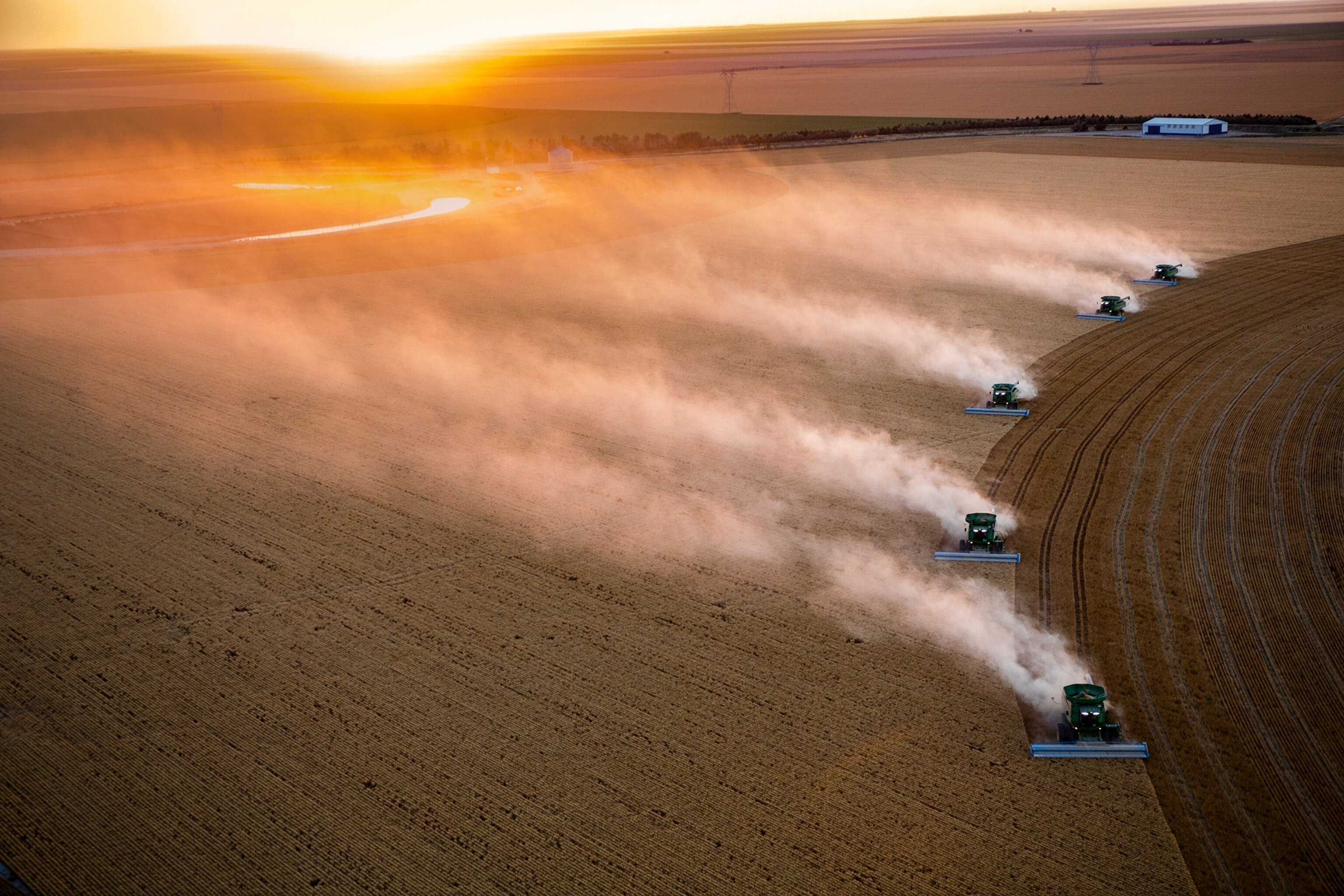 Combines harvesting dry land wheat on the Vulgamore Family Farm just south of Scott City, Kansas.