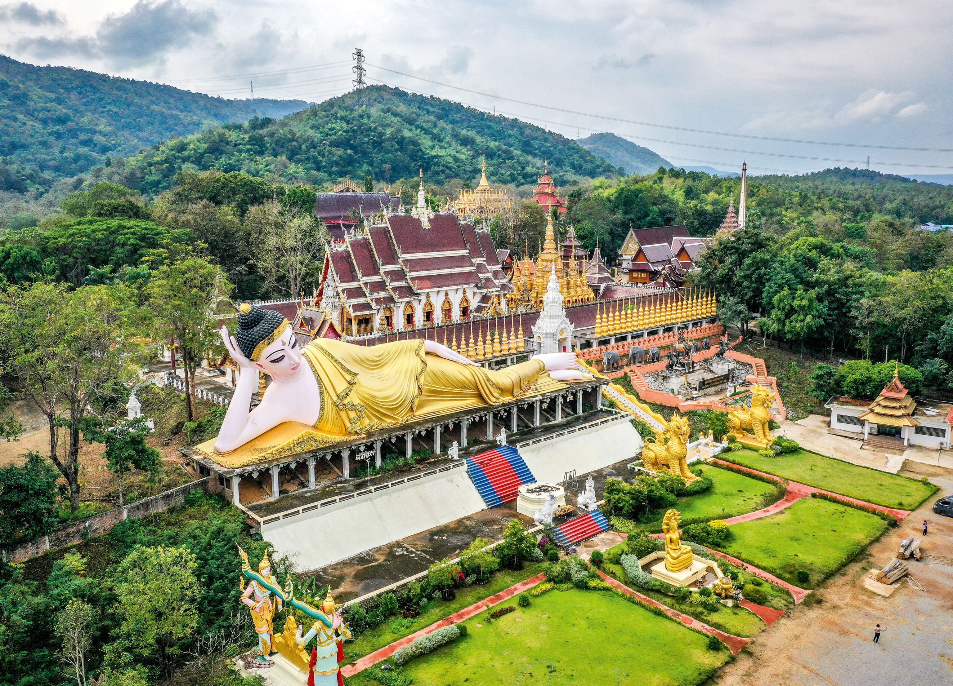 Ornate temple complex surrounded by forested hills