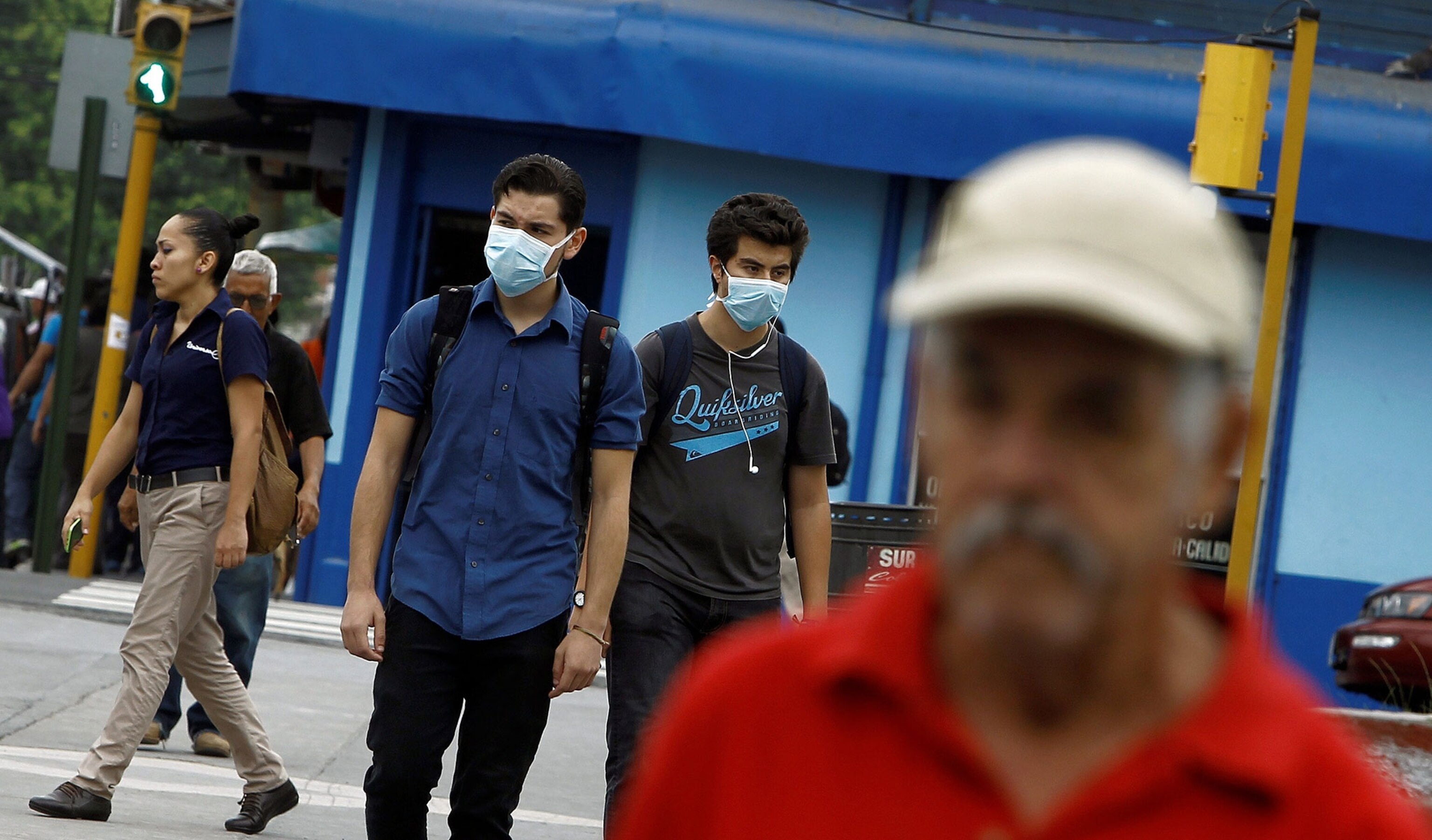 residents wear masks to protect themselves from ash after the Turrialba volcano