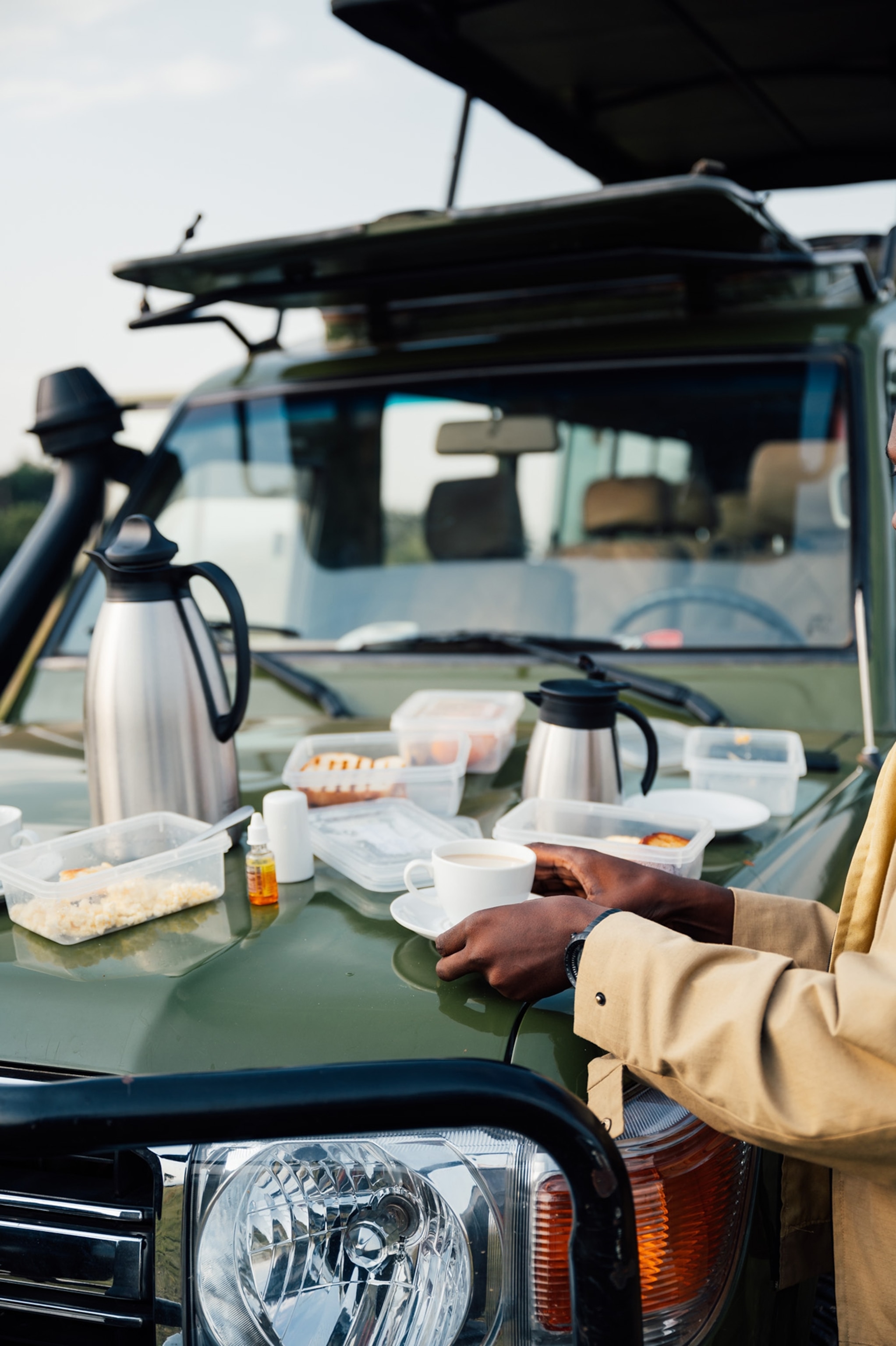 In 2022 I visited Akagera National Park on a field trip to learn more about the impact of the non-profit conservation organisation African Parks. Akagera National Park is under management by African Parks in partnership with the Rwanda Development Board since 2010. Before African Parks assumed management, Akagera National Park faced significant challenges, including widespread poaching, habitat loss, and the extinction of several key species. The park, once a vibrant sanctuary for wildlife, had suffered greatly from the aftermath of the 1994 Rwandan genocide, with human encroachment and illegal hunting decimating its animal populations. The collaborative park management in partnership with communities and local governments has been widely considered a success due to a significant increase in wildlife populations, a reduction in poaching, and a boost in tourism. Now Akagera is home to several keystone species including rhino and elephants. This photo shows a quick coffee break we had before going out on a helicopter patrol with the ranger unit monitoring rhino movements in the park.