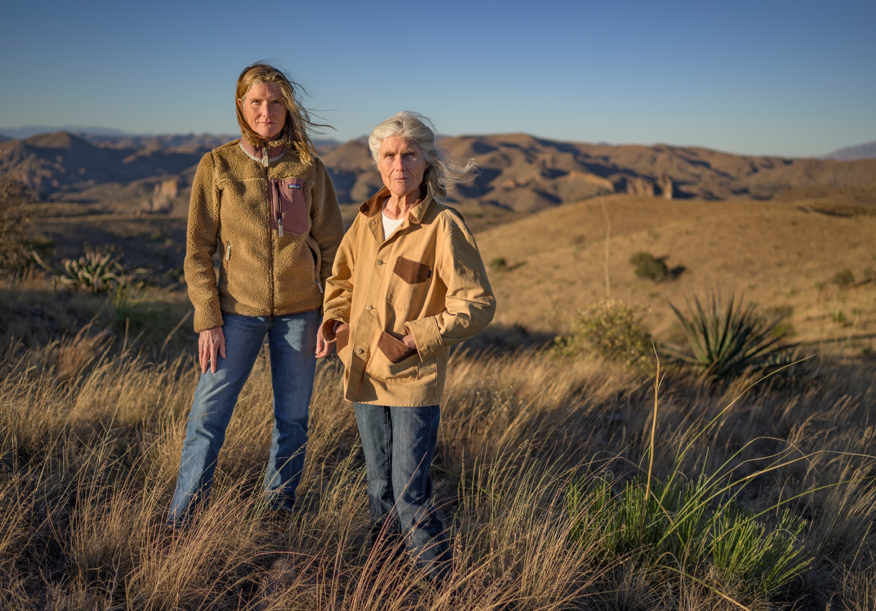 Valer Clark (right), who founded the Cuenca Los Ojos conservation project, walks through La Calavera prairie with her daughter, Valerie Gordon