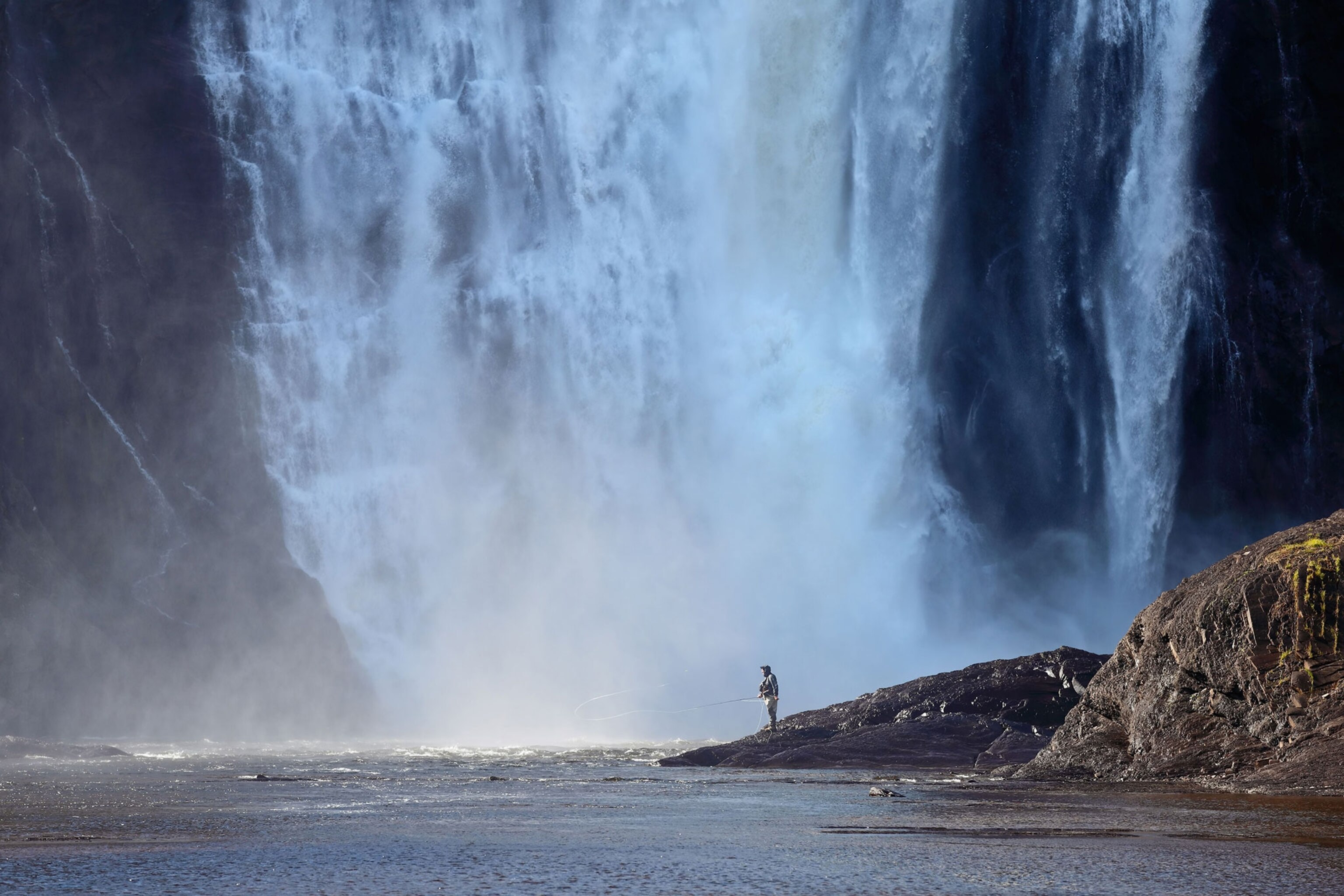 a fisherman at Montmorency Falls in Quebec
