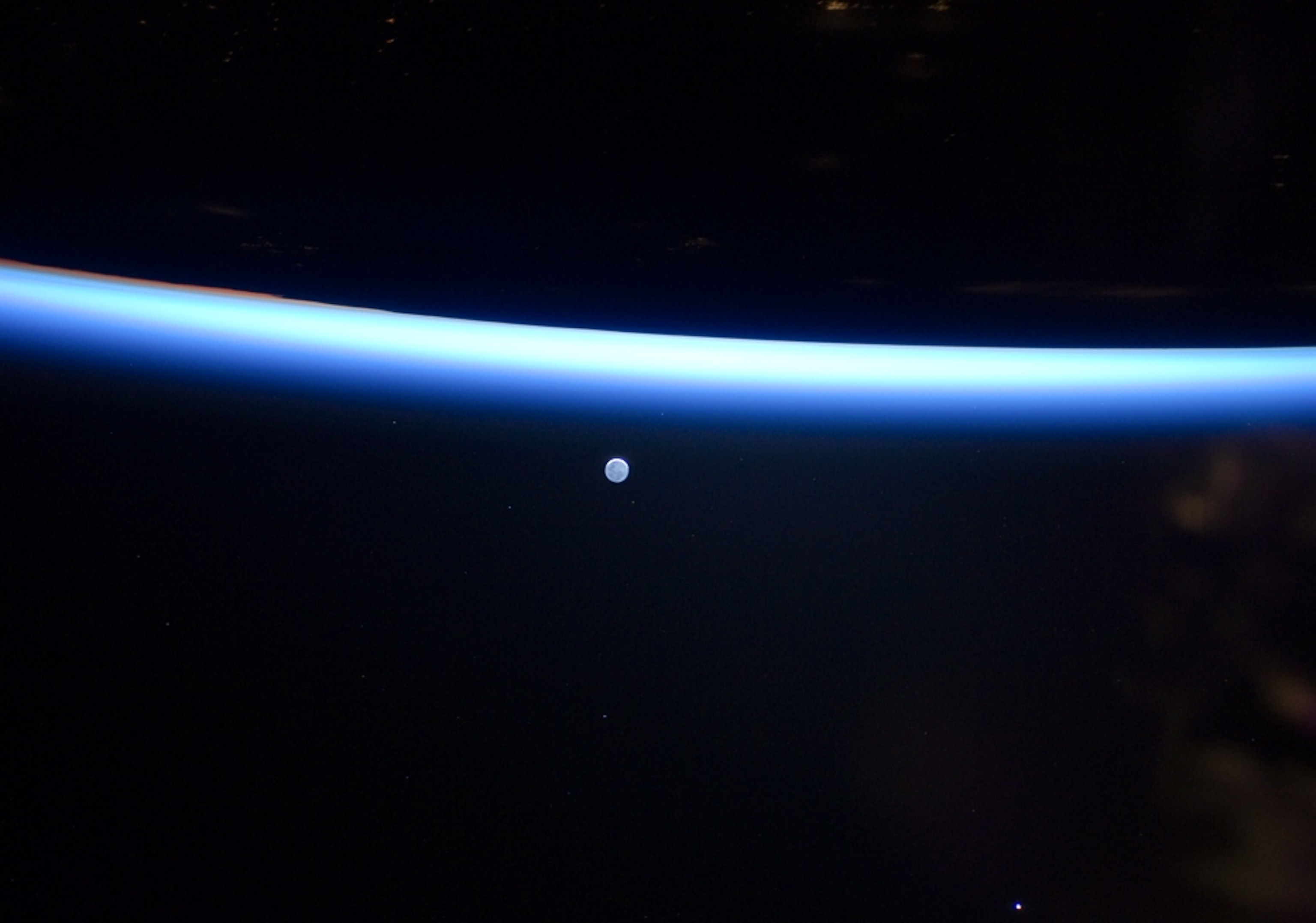 the moon and Earth seen from the International Space Station