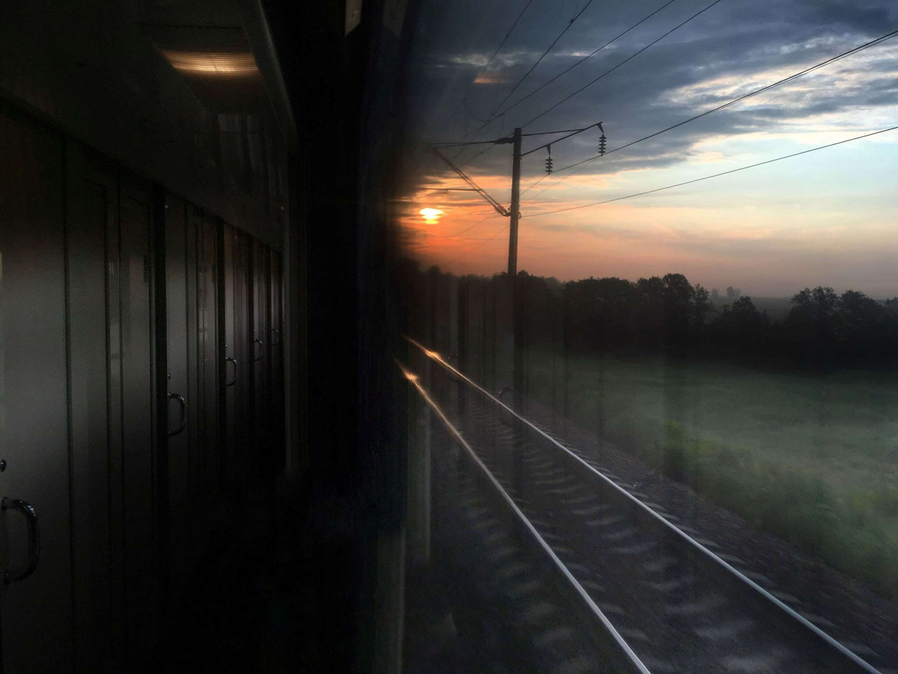 the sun rising over train tracks in Russia