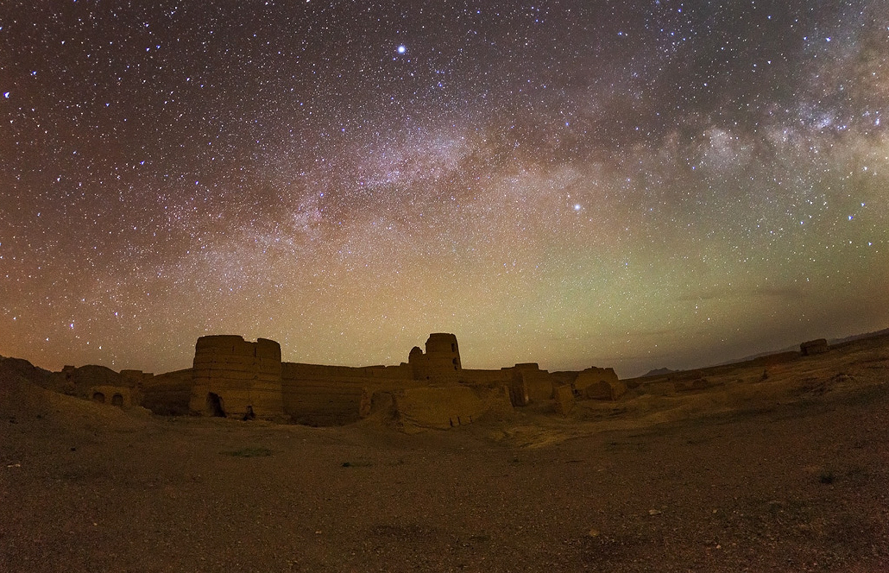 a castle in central Iran with the Milky Way in the background
