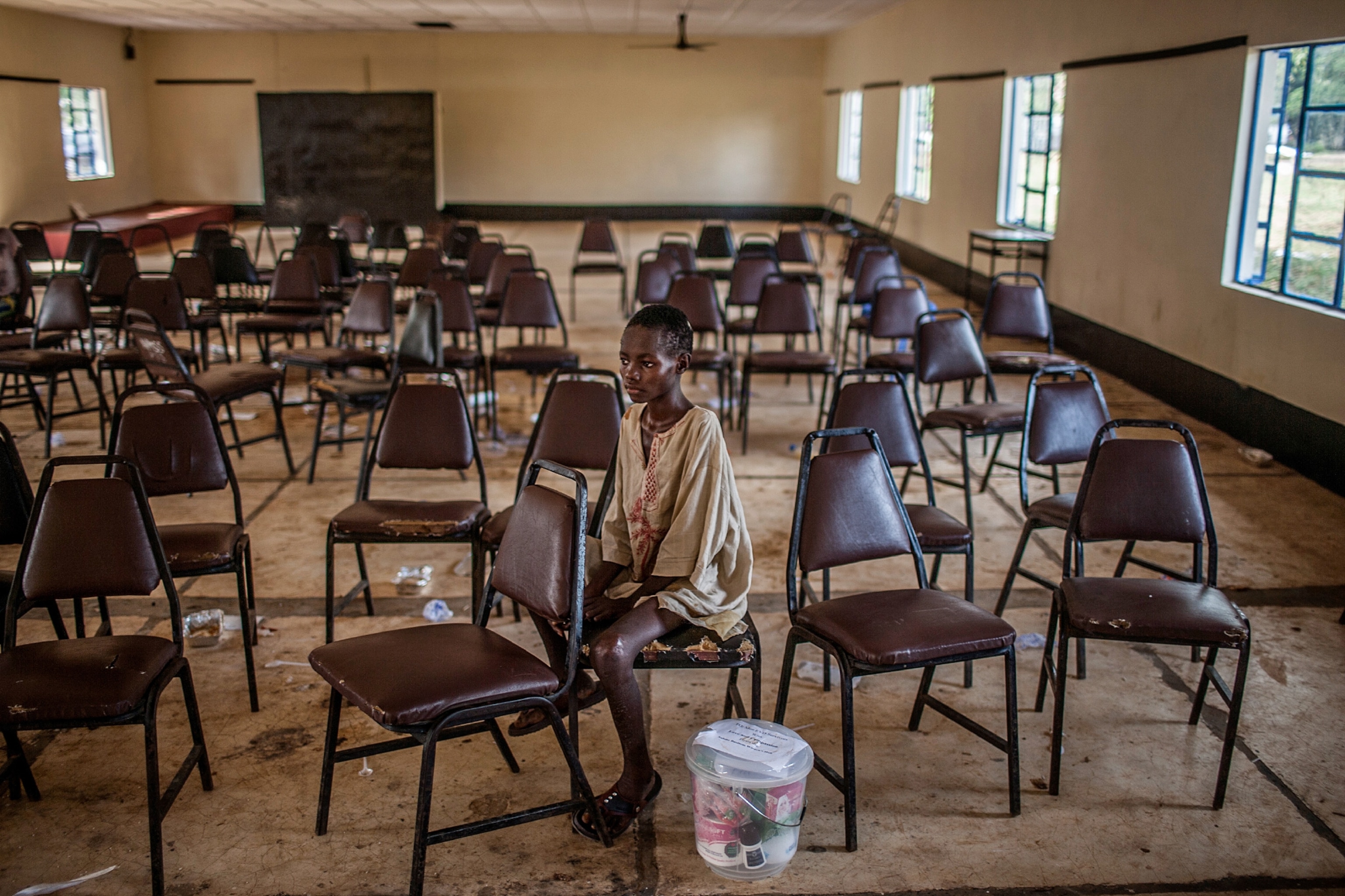 a young girl Molai Kamara sitting alone at the Hastings Ebola Treatment Center in Hastings, Sierra Leone