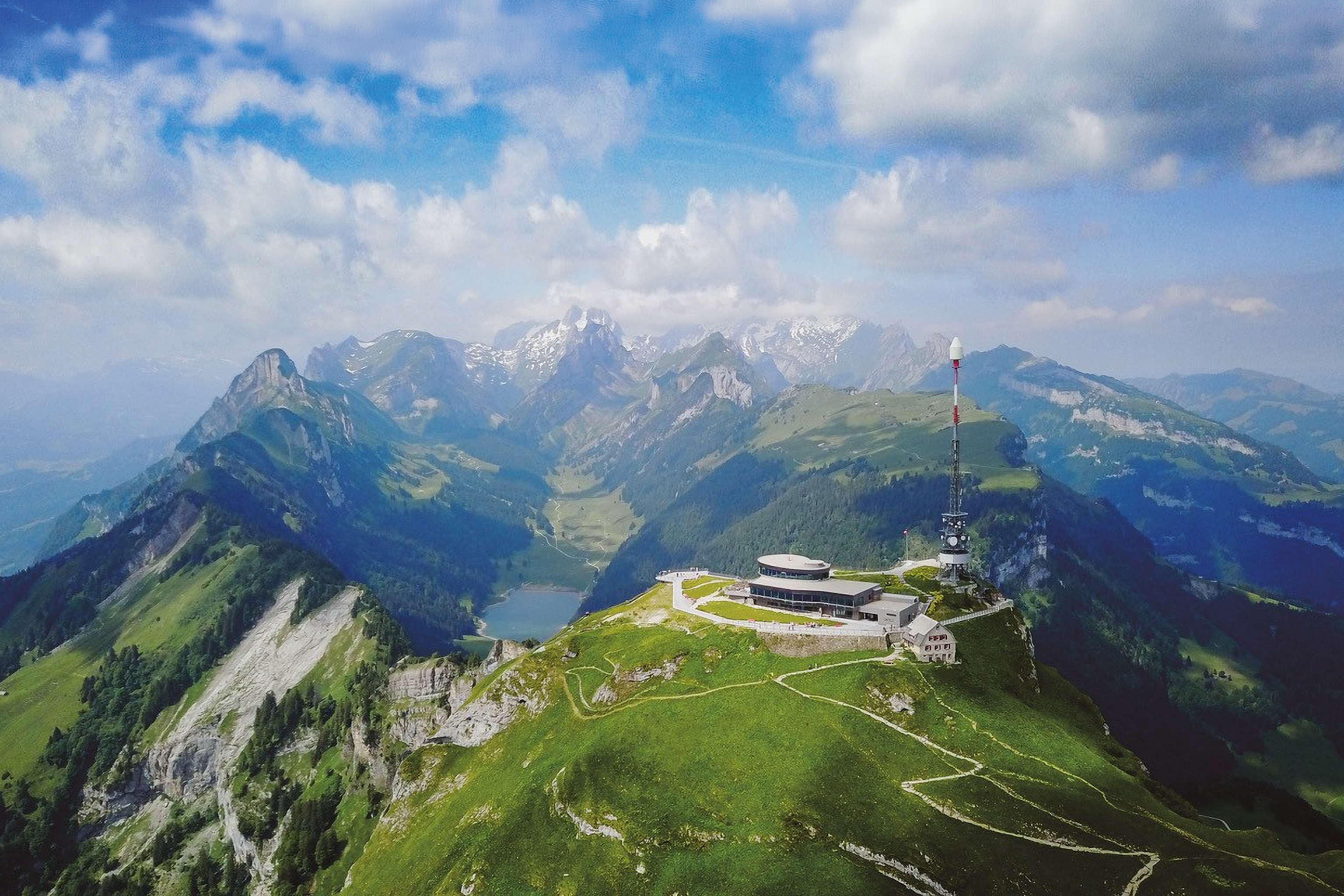 A restaurant sat at the top of a high-altitude peak, overlooking a dramatic valley below.
