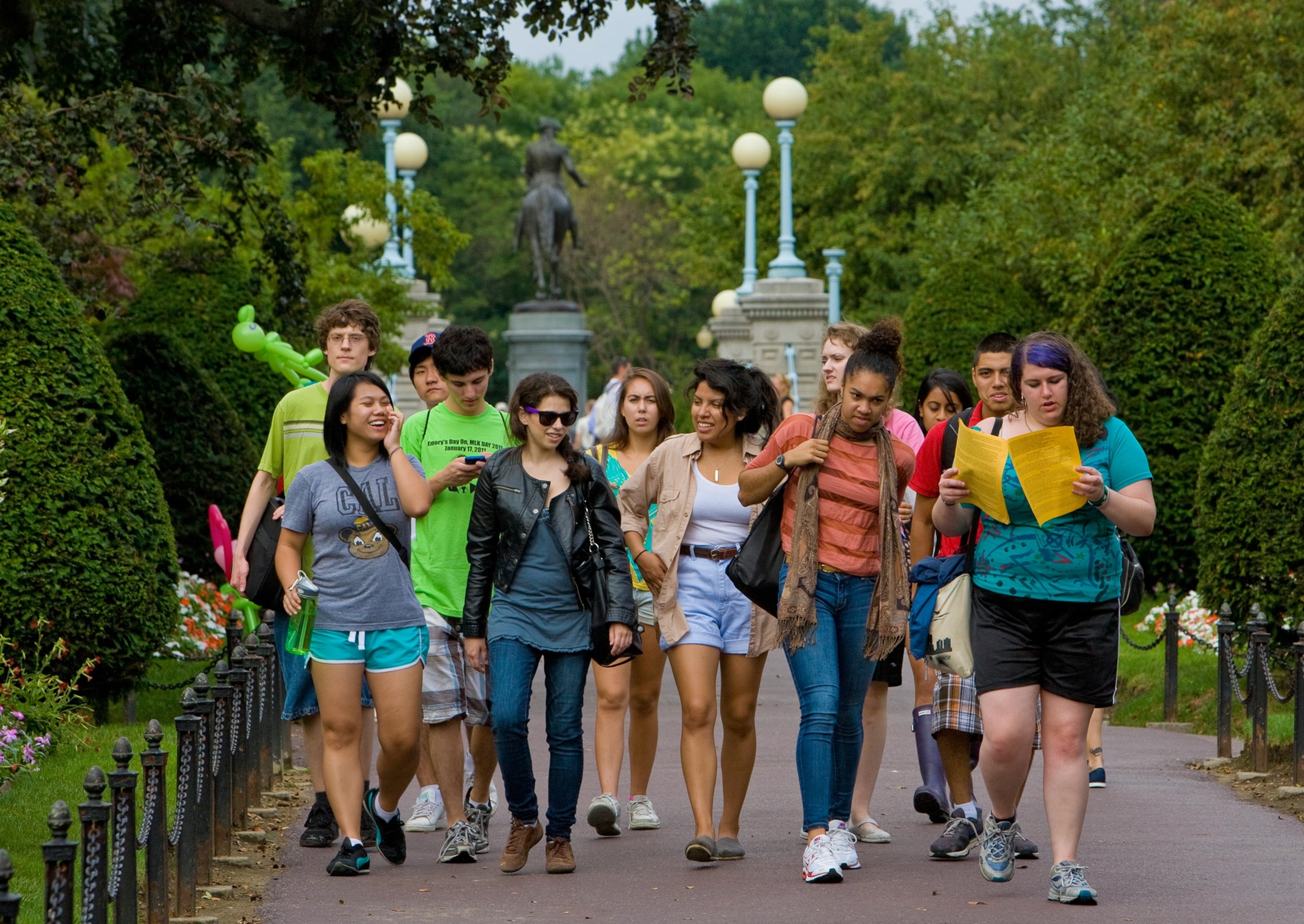 a group of exchange students walk through the Public Garden in Boston.