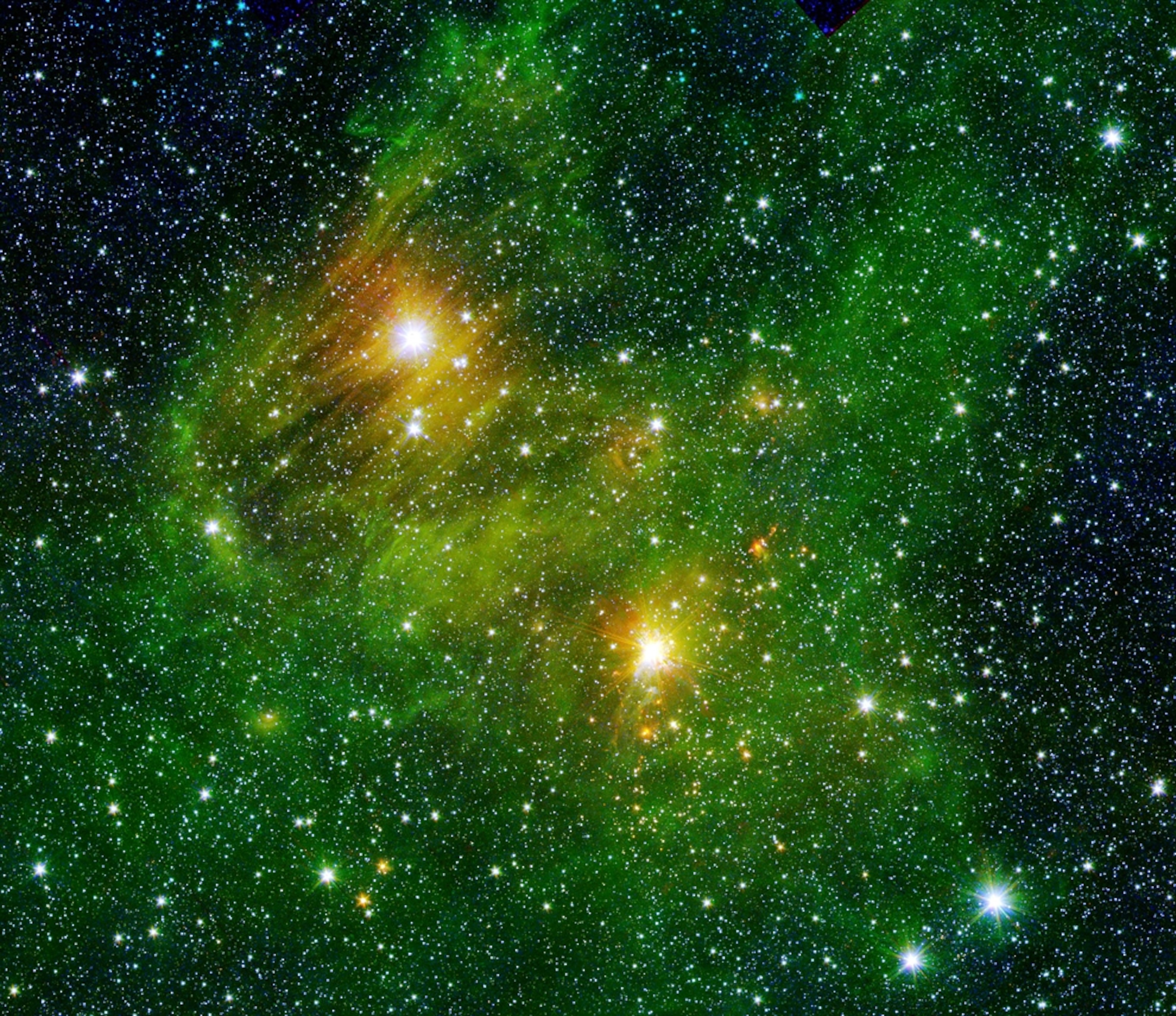 Picture of two bright stars on the edges of the Milky Way lighting up clouds of polycyclic aromatic hydrocarbons.