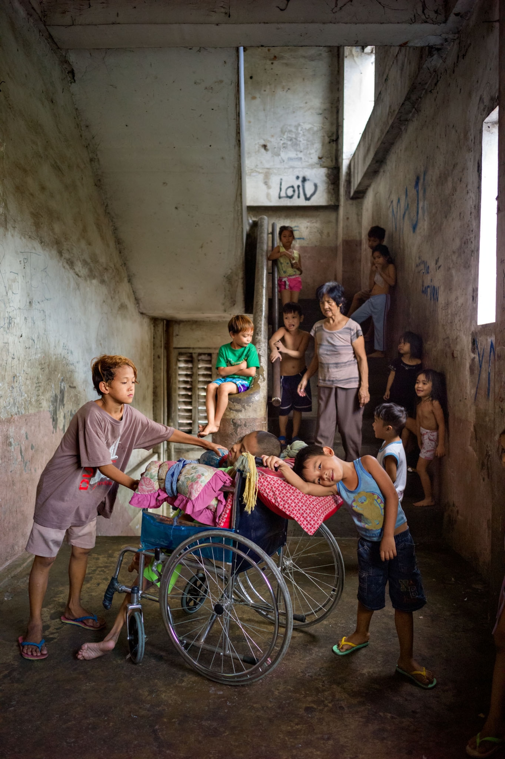 kids playing with another child in a wheelchair