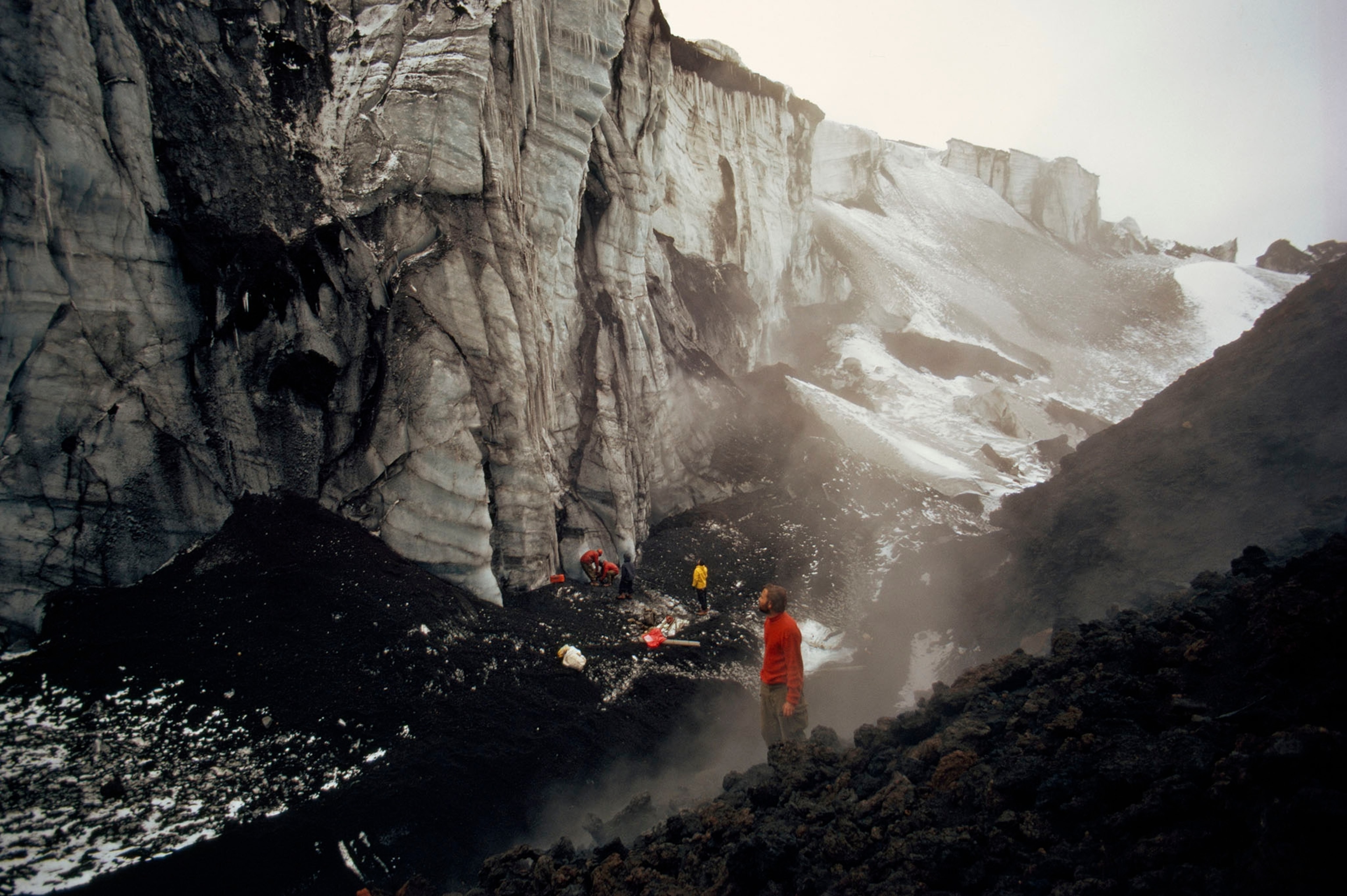 Fumaroles heat a Deception pool to 100° F, giving Russian scientist Leonid Govorukha a hot bath amid falling snow and chill air.