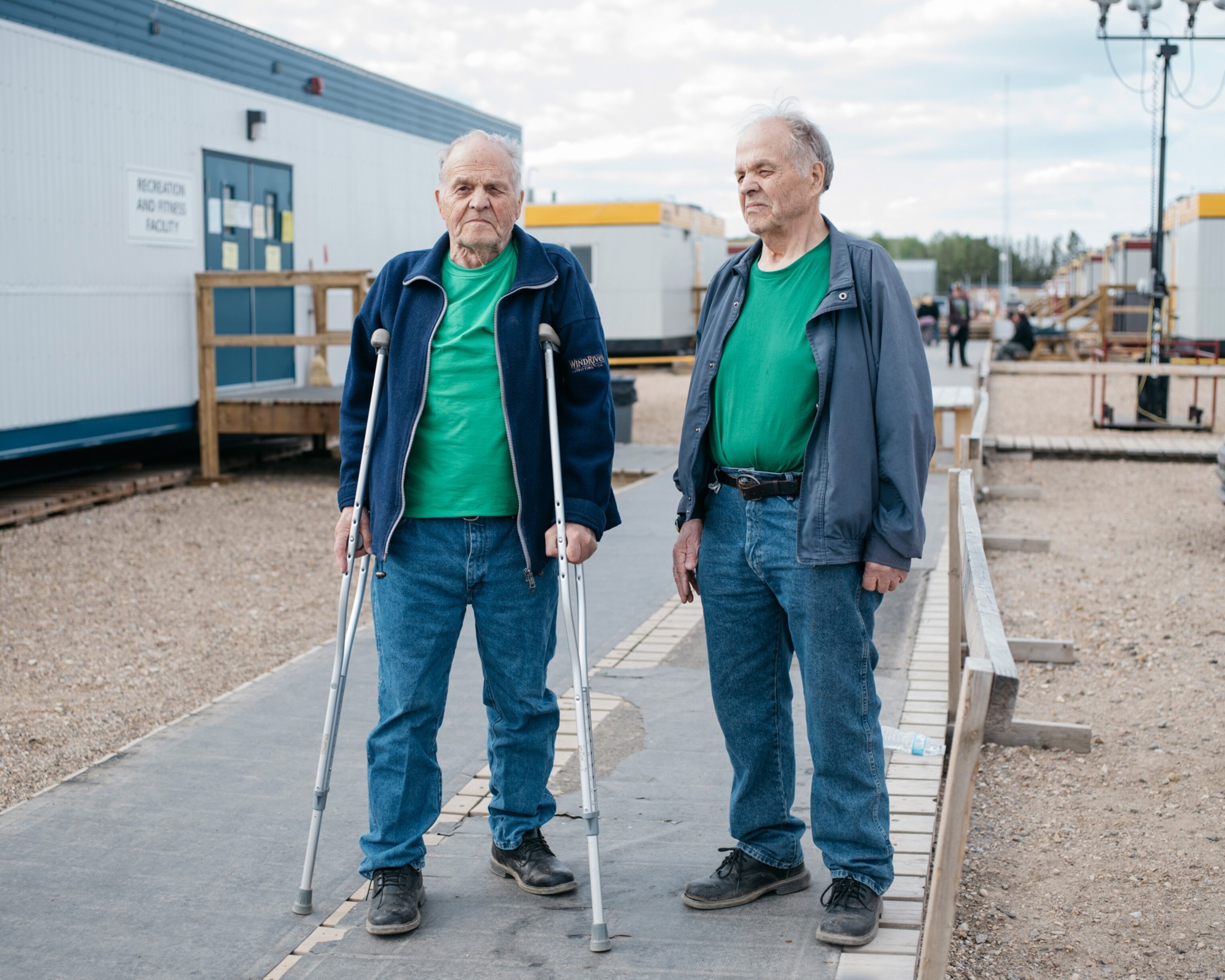 twin men in green shirts