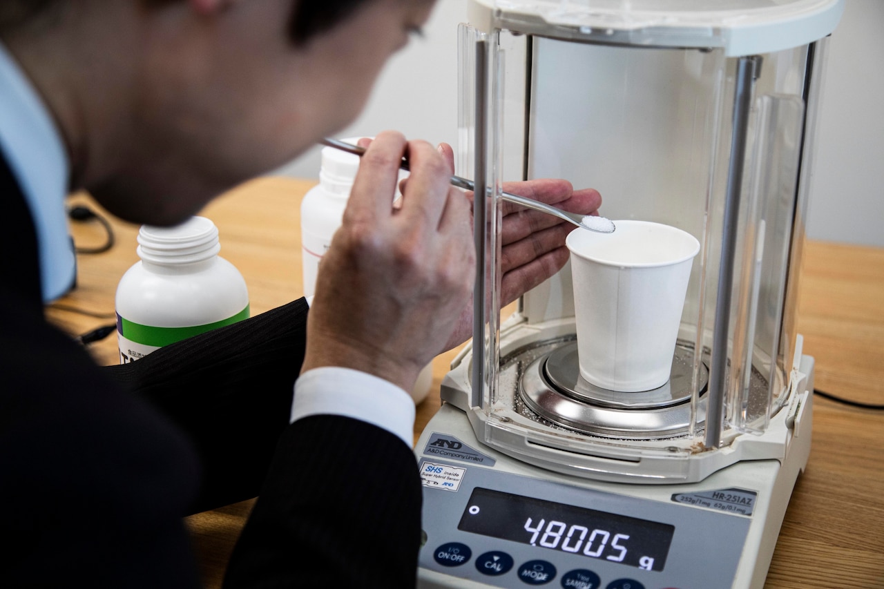 Meiji University Professor Homei Miyashita measuring the weight of salt.