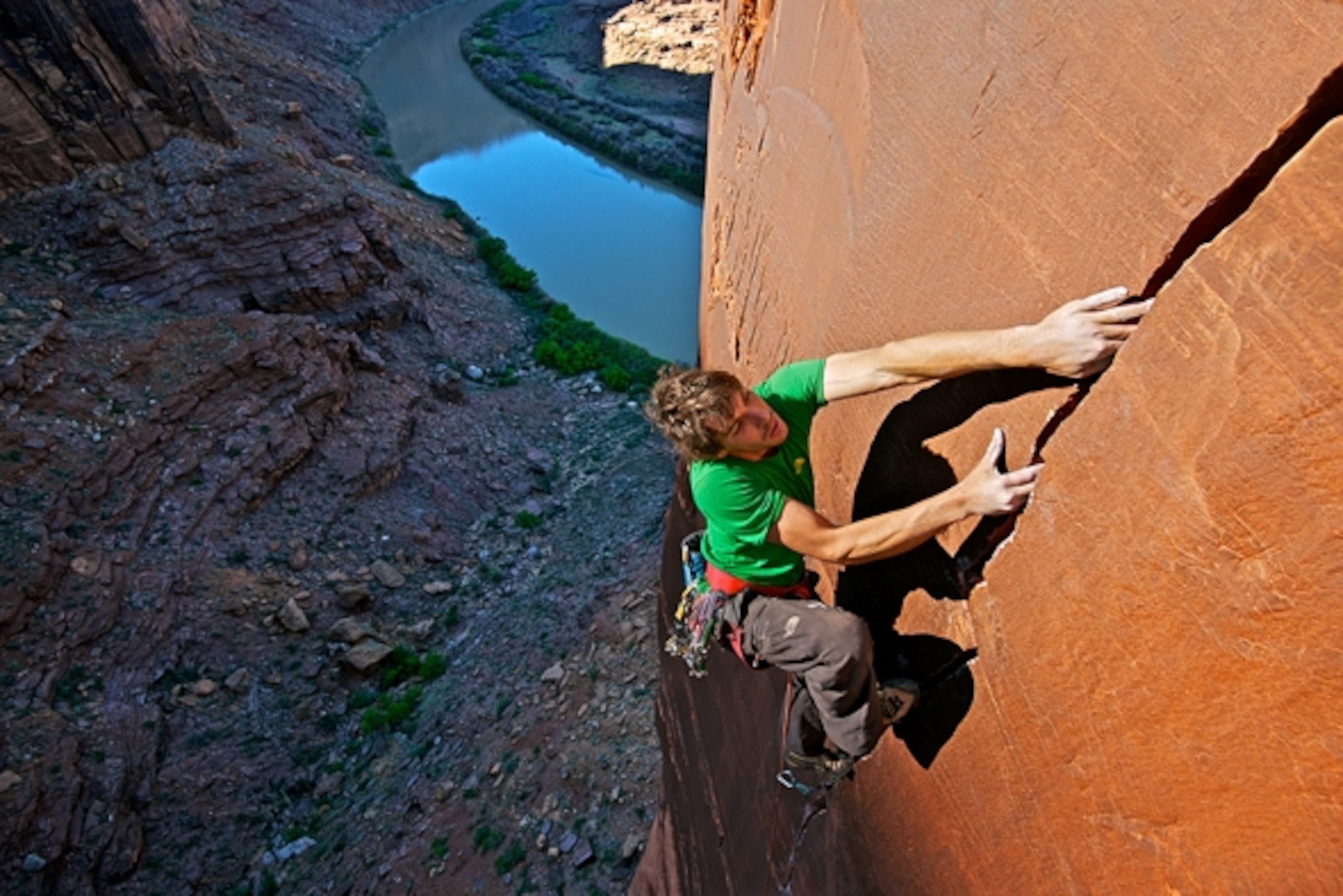 Alex Honnold on the first ascent of the Green Dragon 5.13. a 3 pitch masterpiece in Labyrinth Canyon, UT with the Green River below. Photograph by Celin Serbo