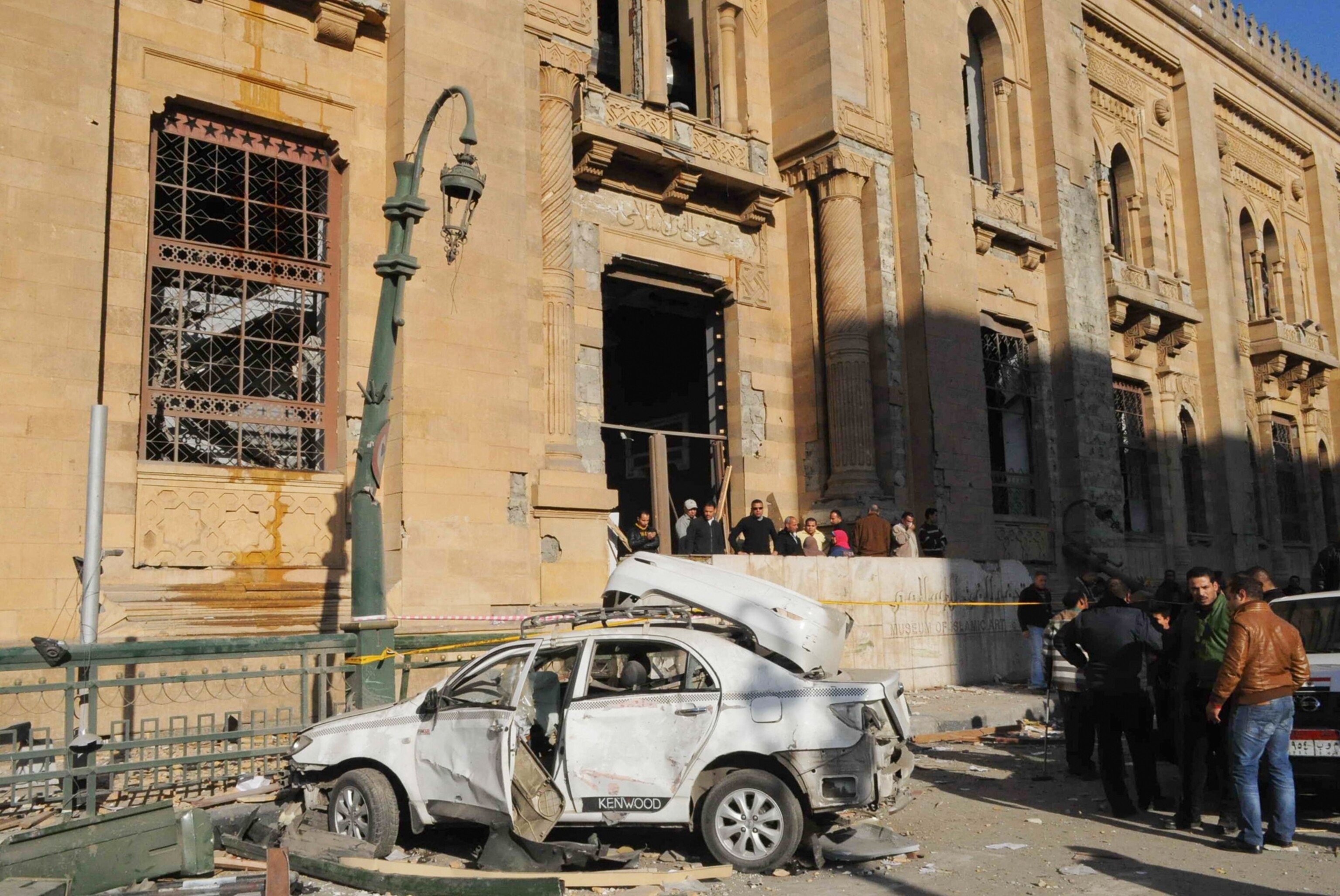 Egyptian security officers cordon off the site of a car bomb attack targeted Cairo security headquarters.