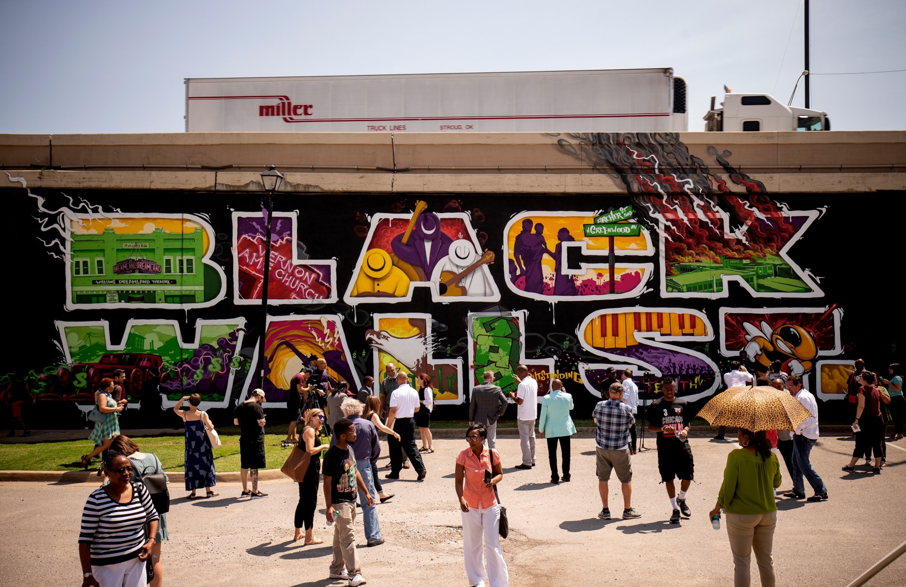 people walk in front of black lives matter in tulsa oklahoma