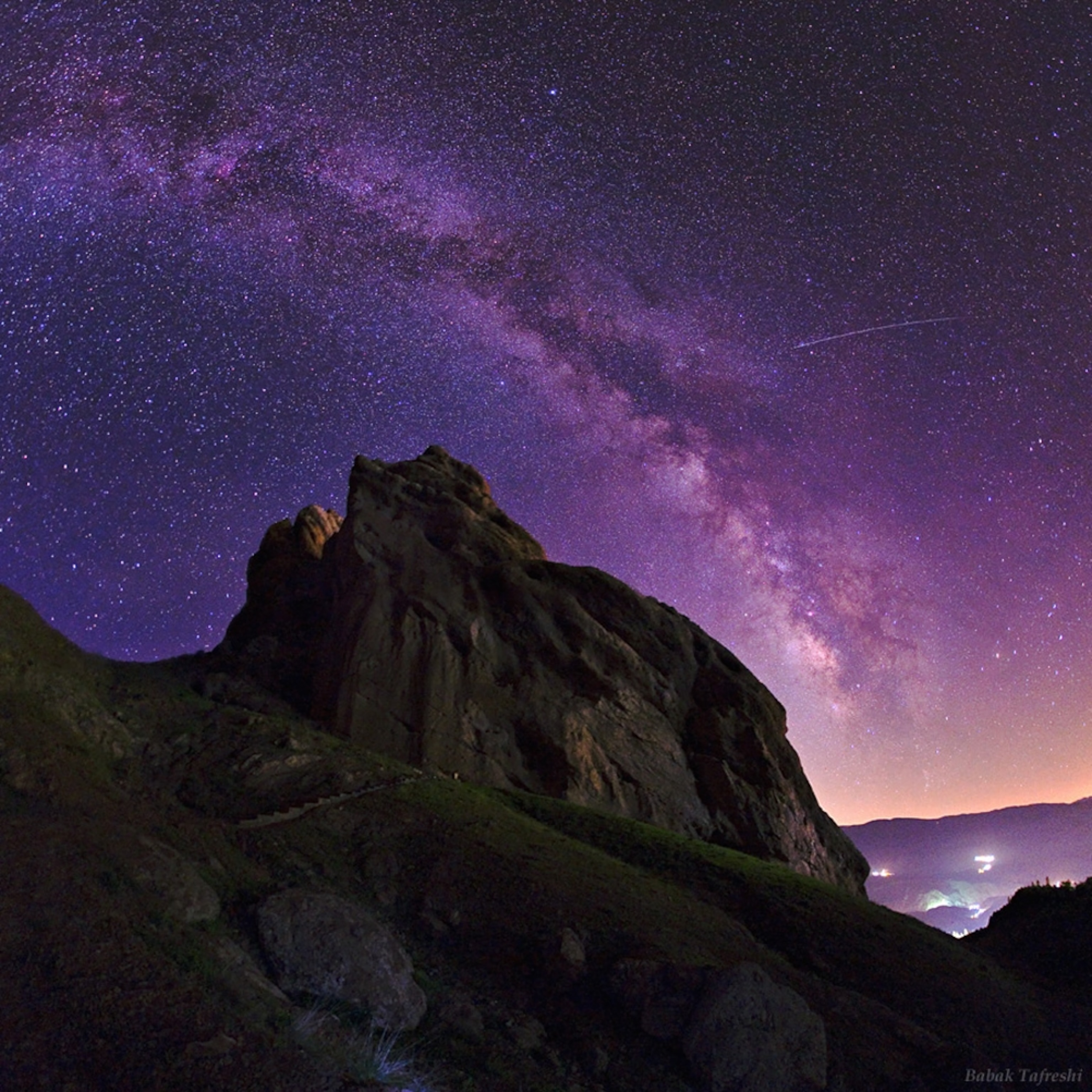 A long-exposure picture shows the night sky over a mountain fortress in Iran.
