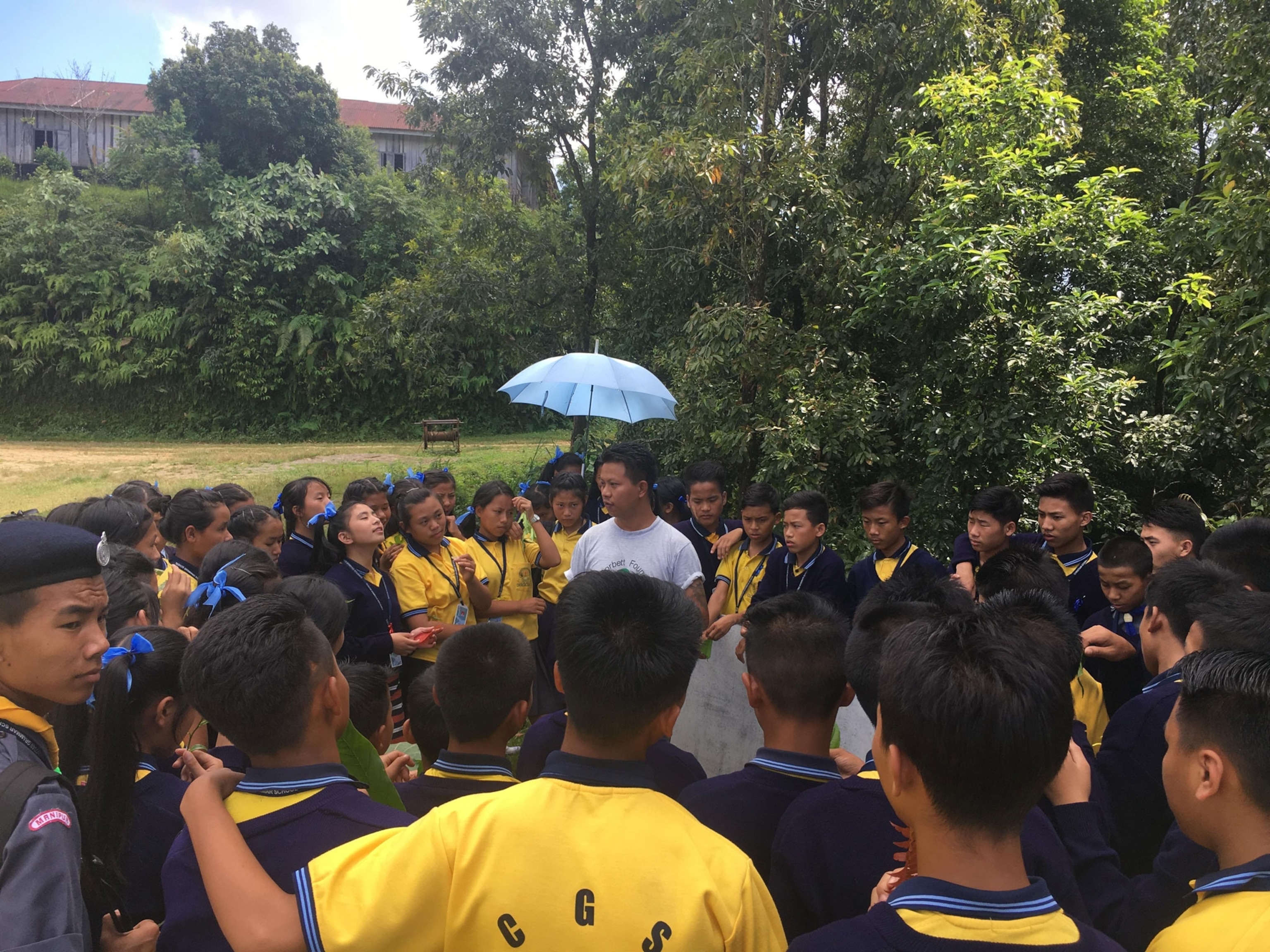a man surrounded by school children