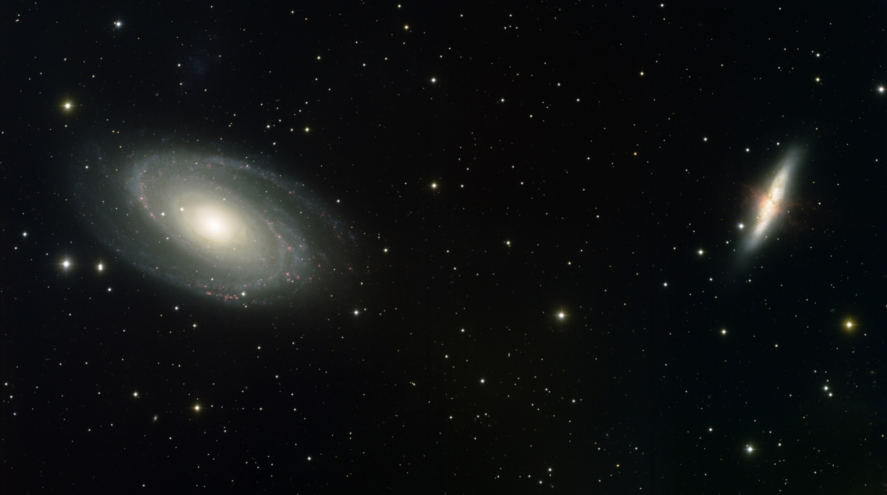 M81 (left) and M82 (the galaxy on the right) are two relatively nearby galaxies
