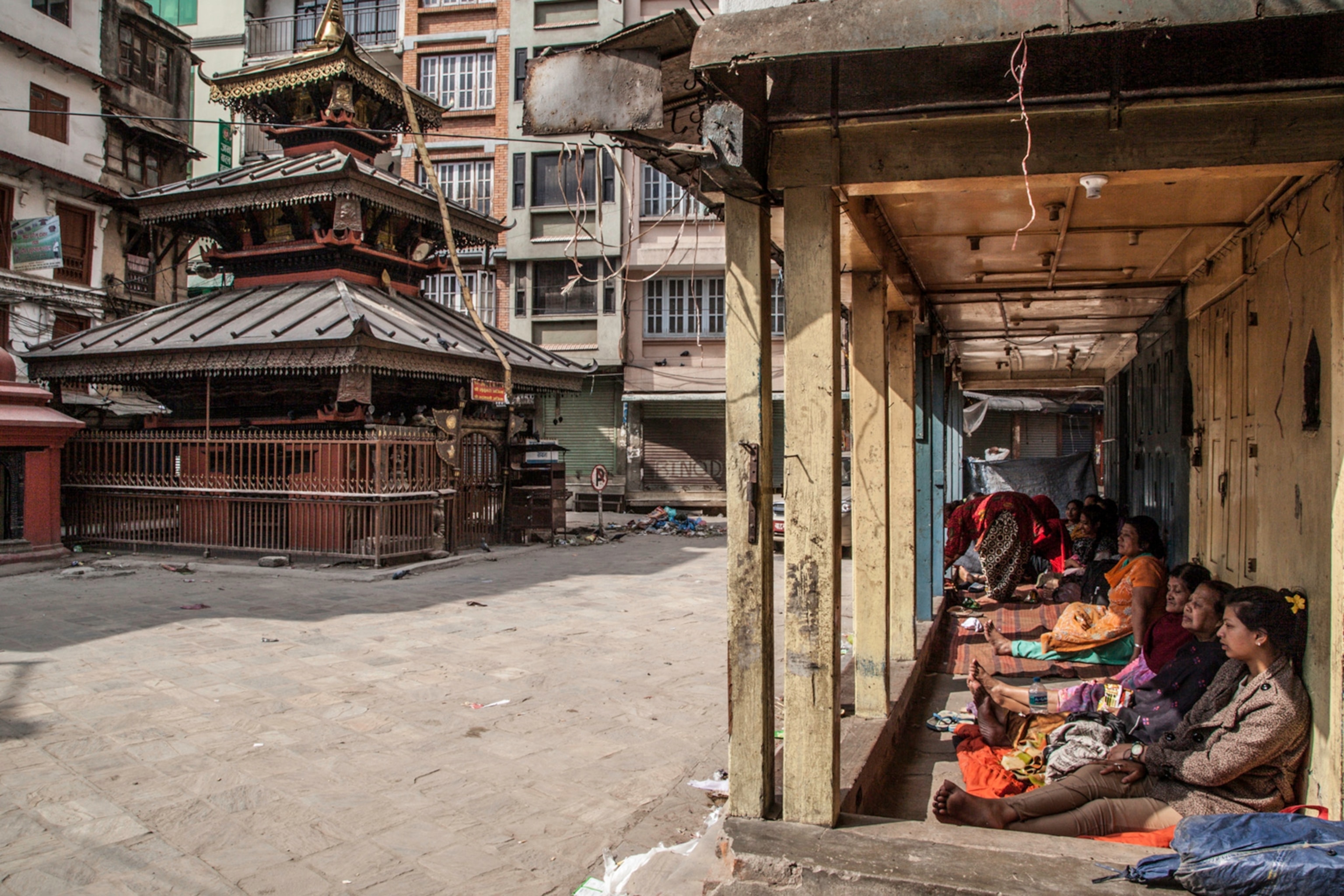 Waiting in silence, Nepalese left their homes and rest together in Ason Tole.