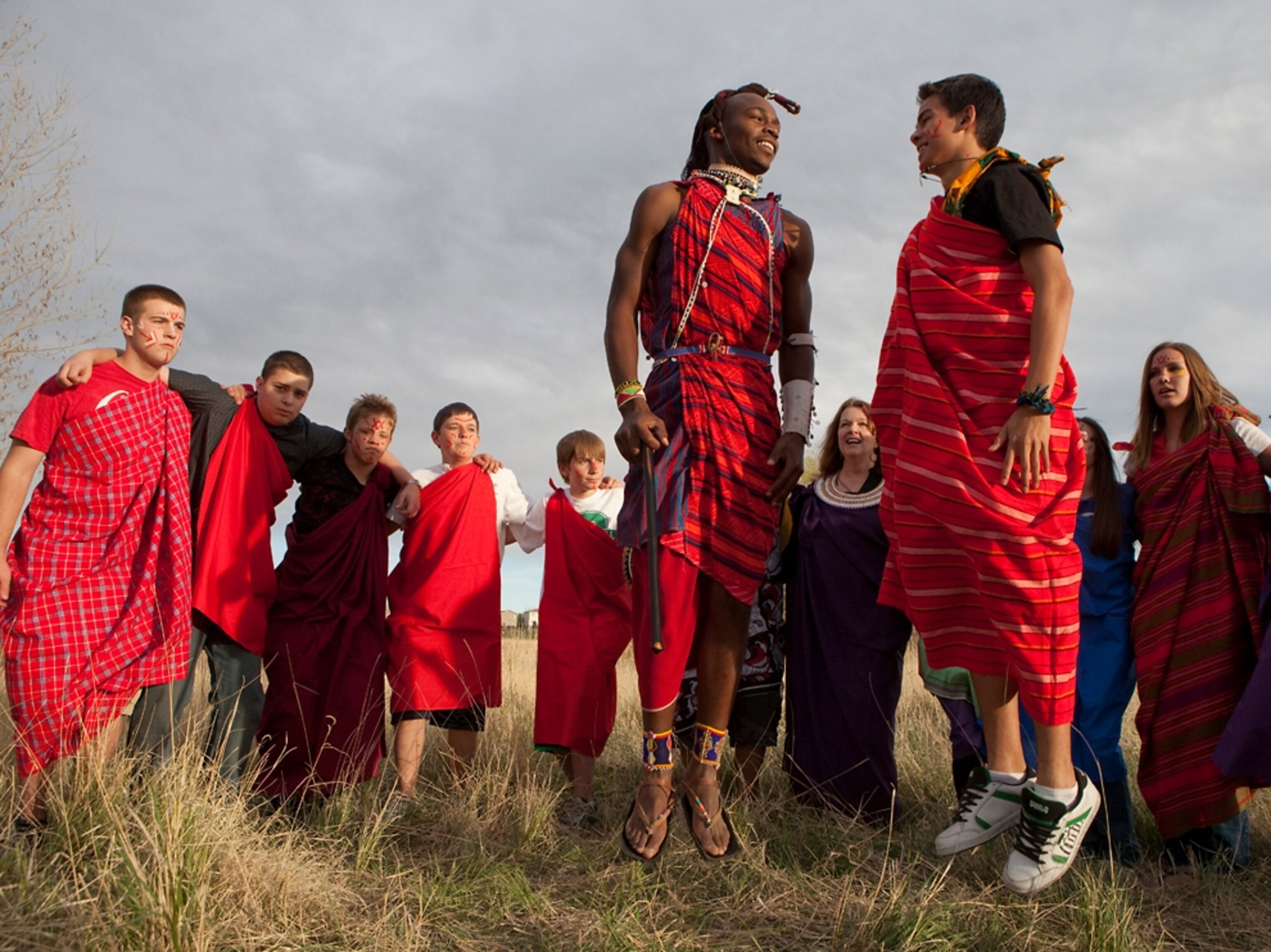 Samwel Melami and Paula Busey with students