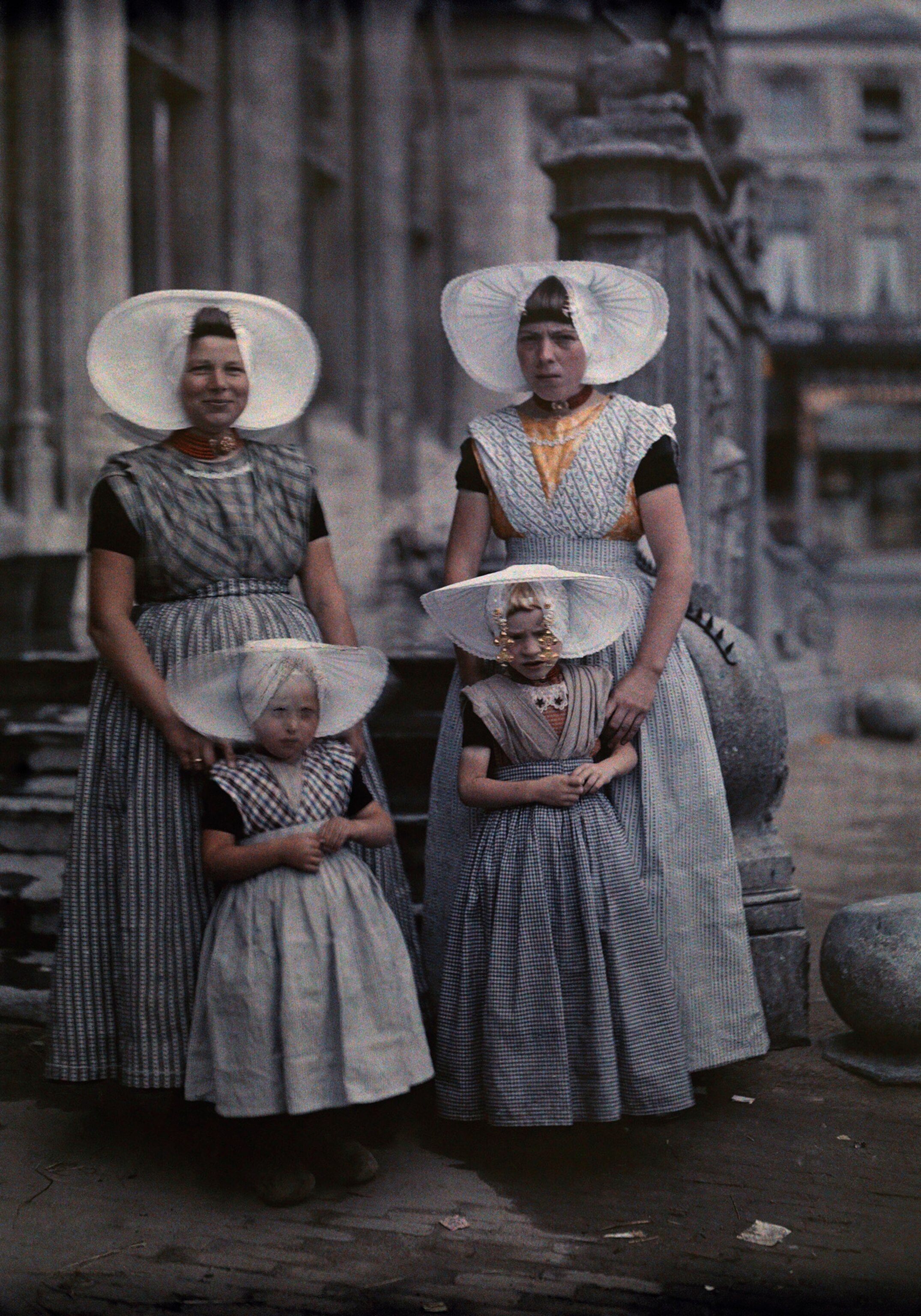 women posing with their daughters all in Zeeland folk costume in Middelburg, Netherlands