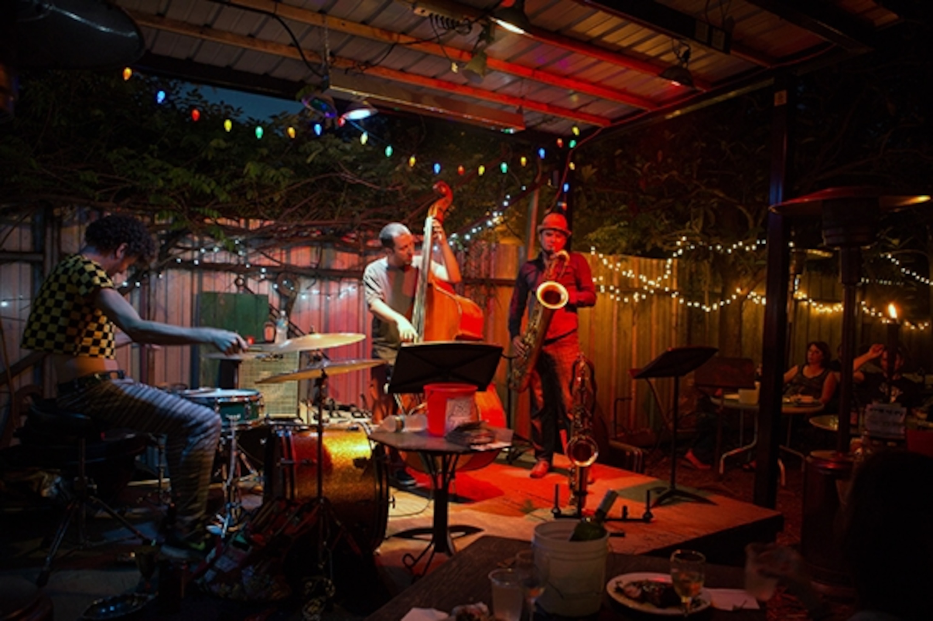 The Jesse Morrow Trio perform in the backyard of Bacchanal, a wine and cheese bar in the Bywater neighborhood. (Photograph by Kris Davidson)