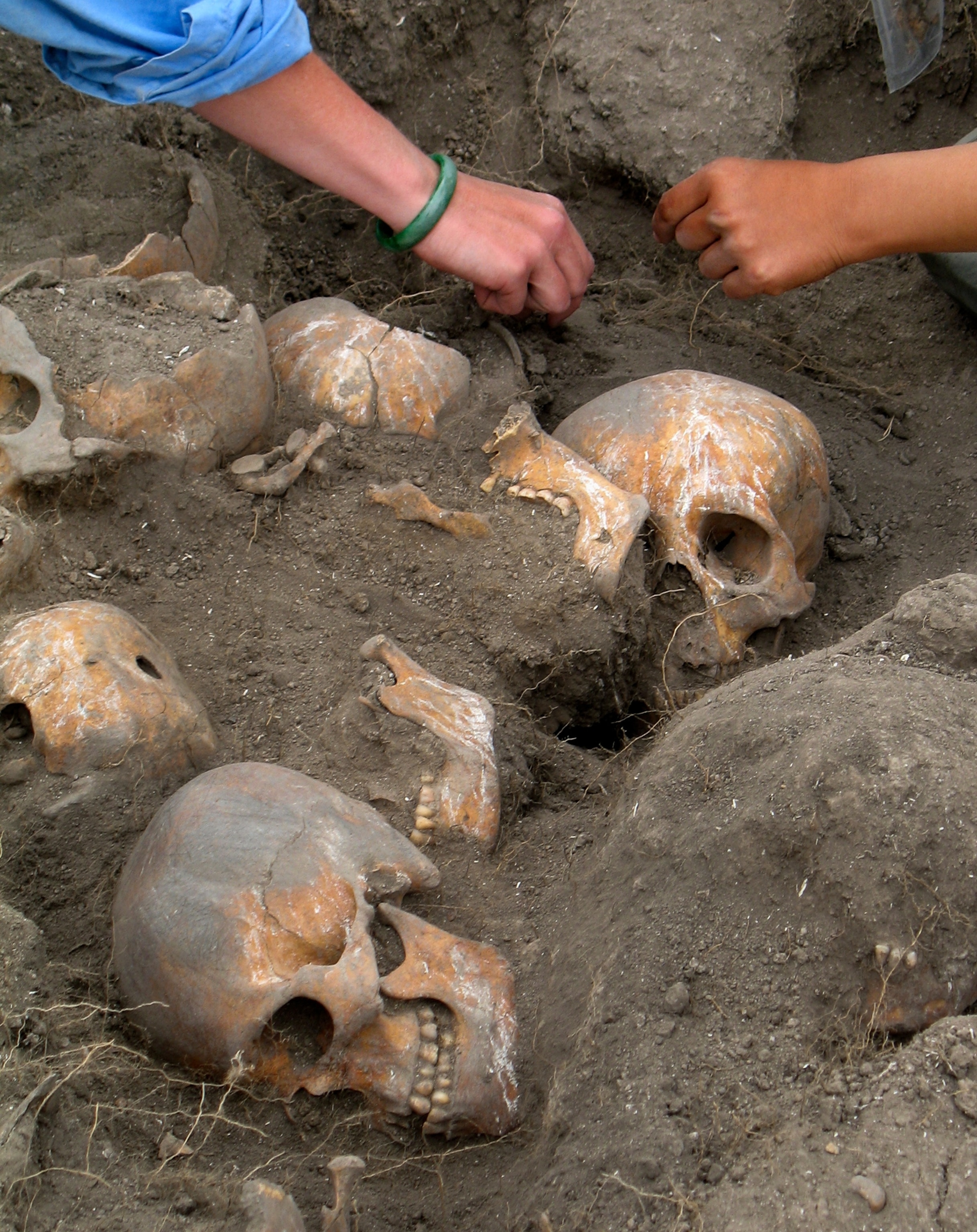 Archaeologists look at skull fragments at a shrine near Mexico City, Mexico.