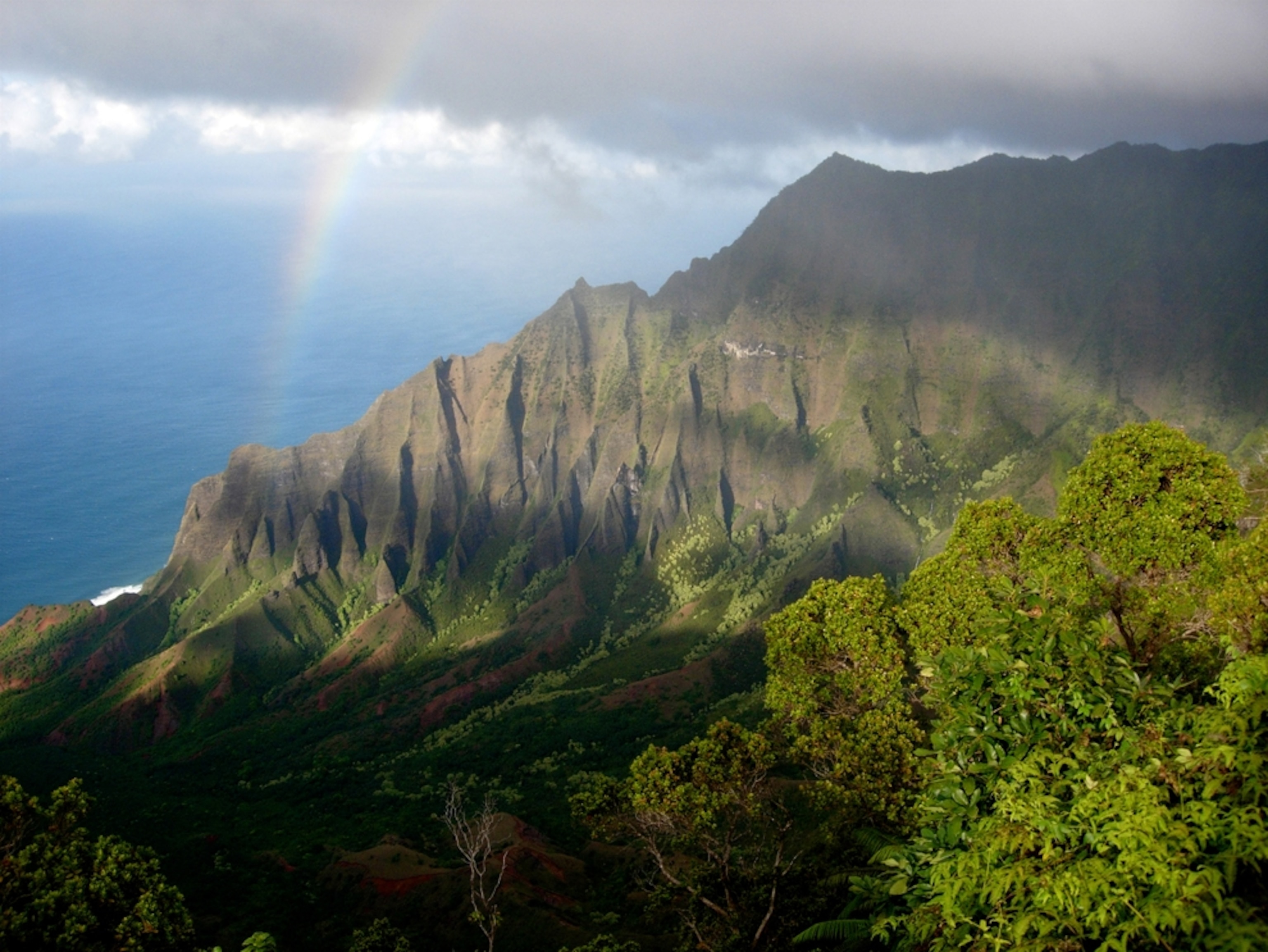 Rainbow and clouds over coastline