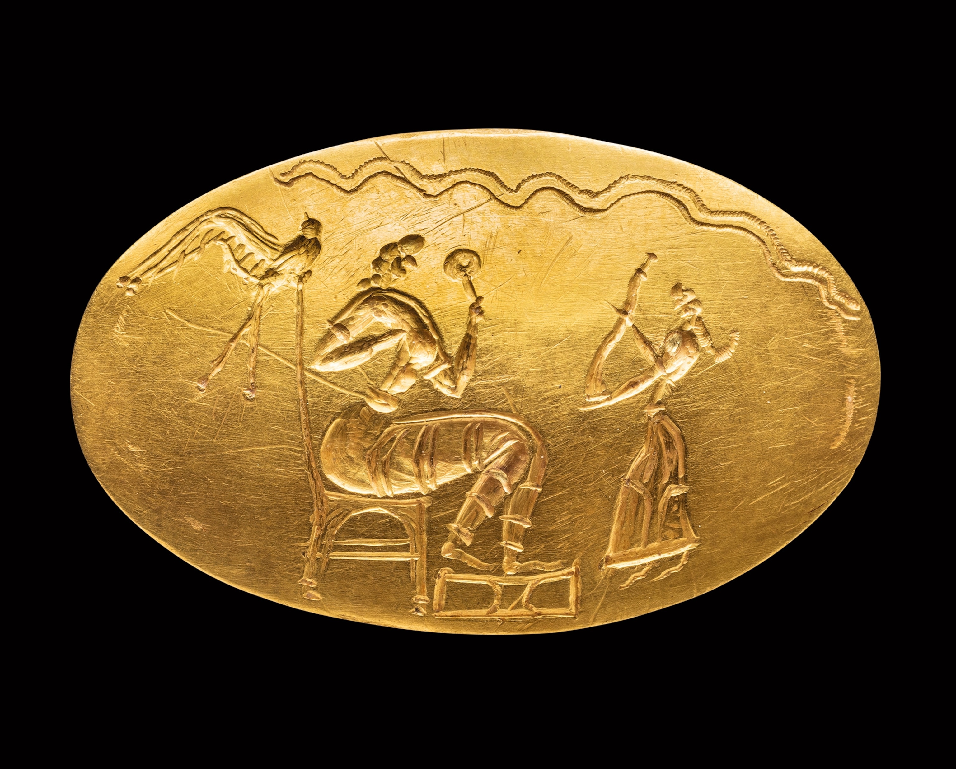 Holding a mirror, an enthroned female figure (thought to be a goddess) receives a bull’s horn.