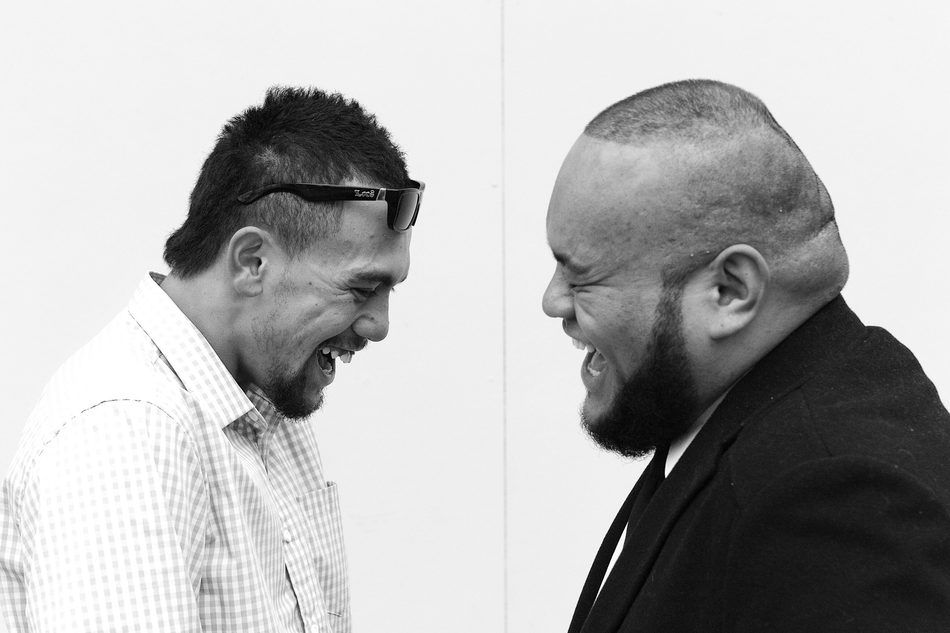 two Maori gentlemen laughing out loud.