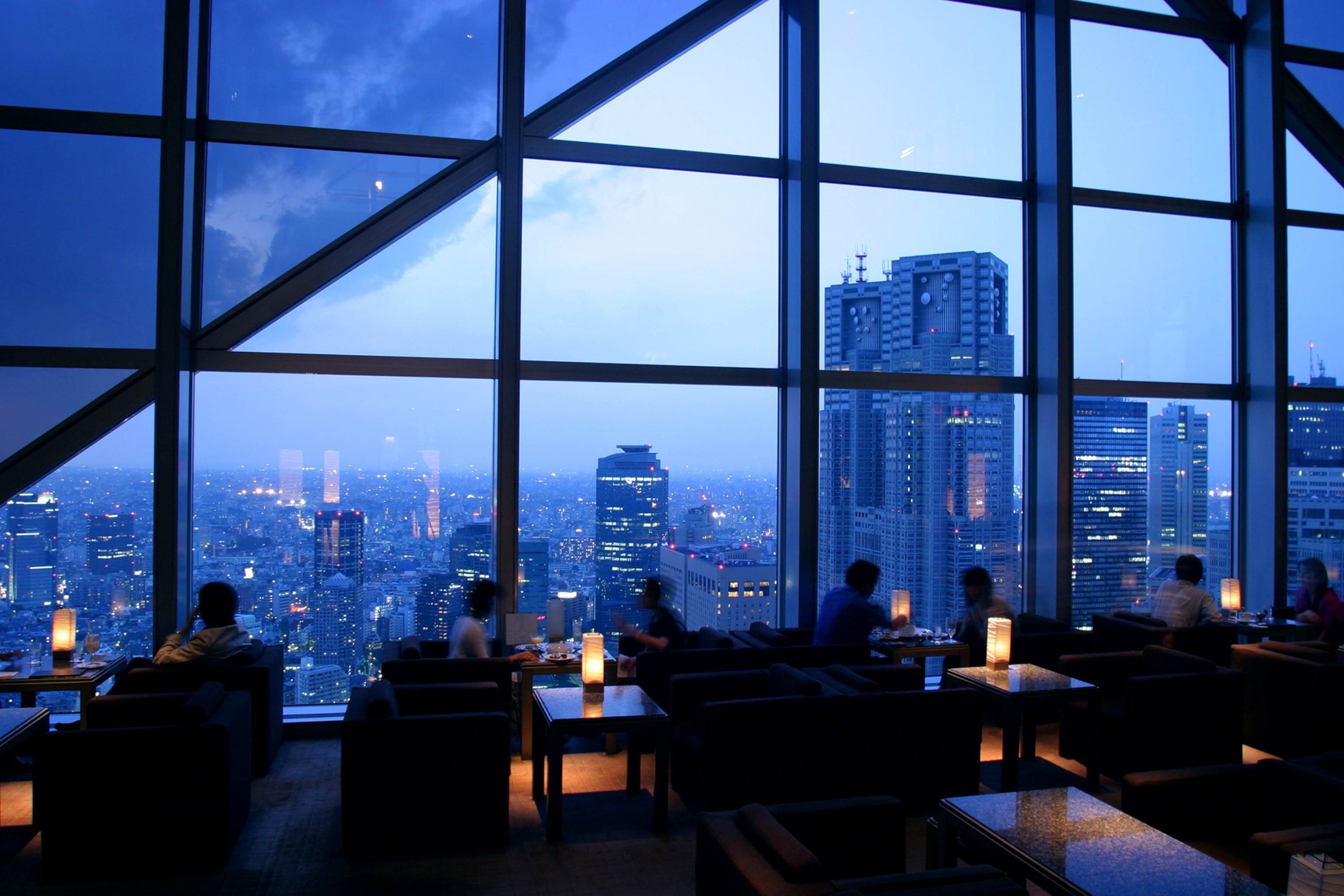 patrons in Sky Bar, located at the top of the Park Hyatt overlooking Tokyo, Japan