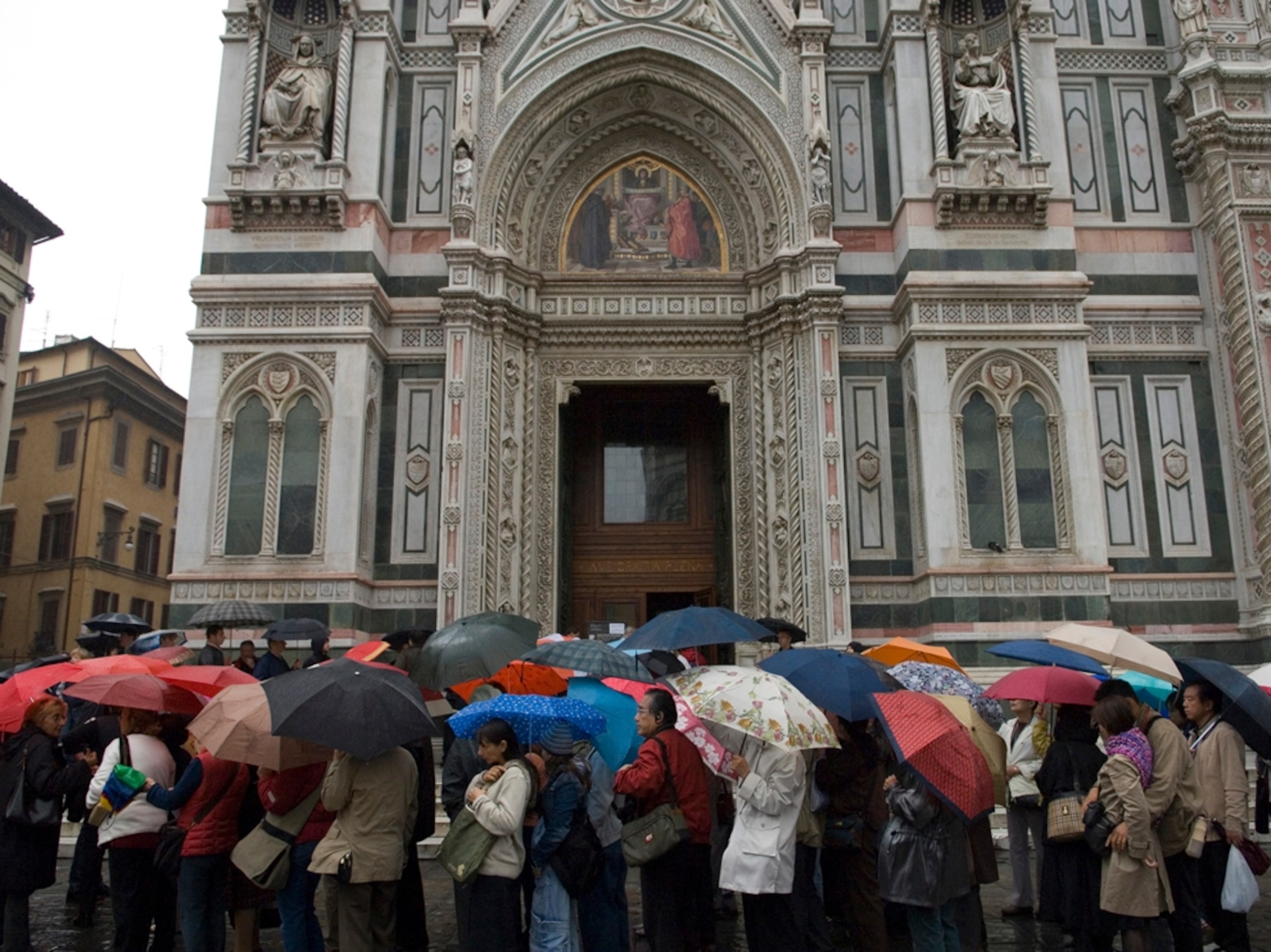A group of tourists with umbrellas in the rain, Florence, Italy