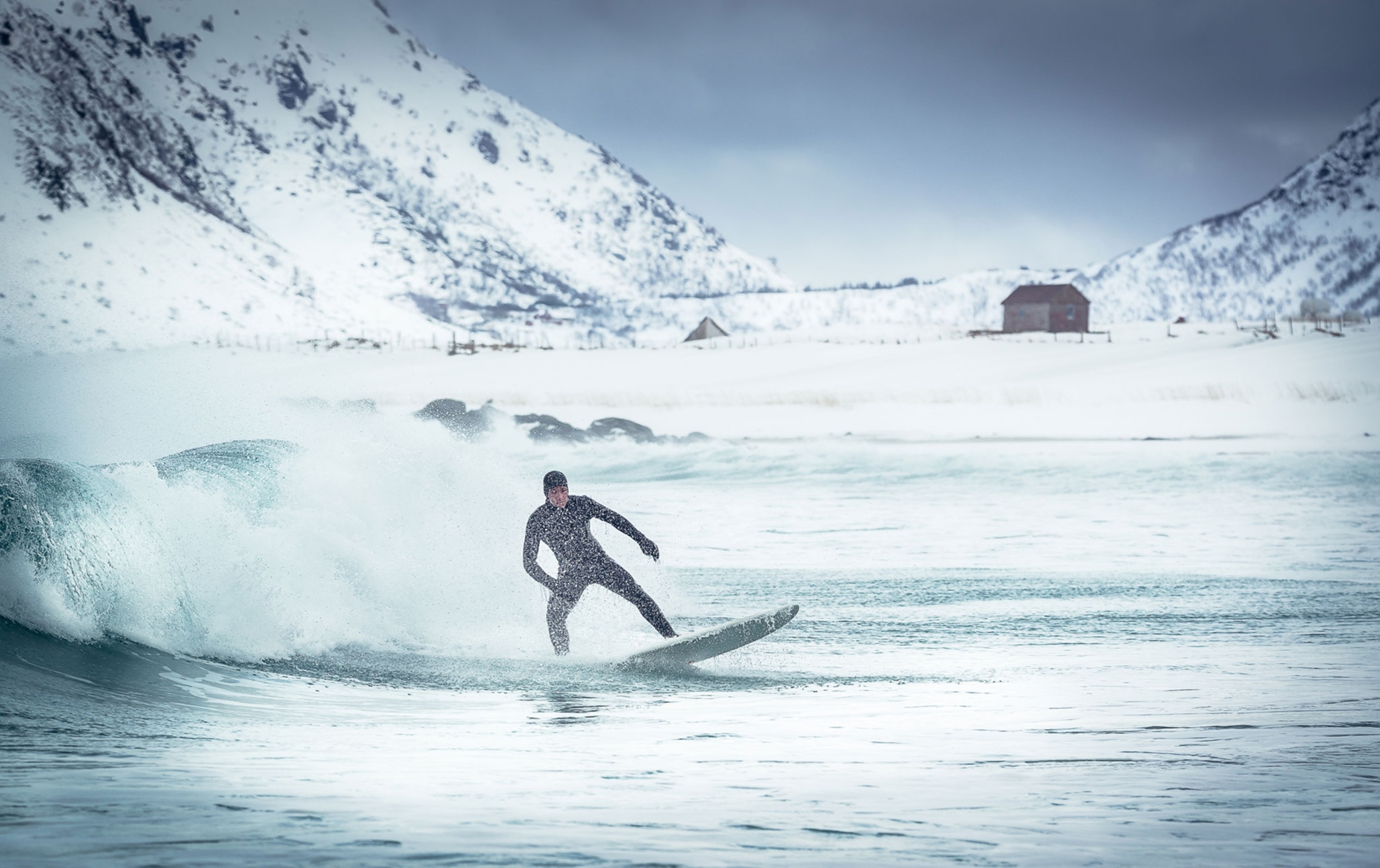 a surfer braving the freezing temperatures of Norway