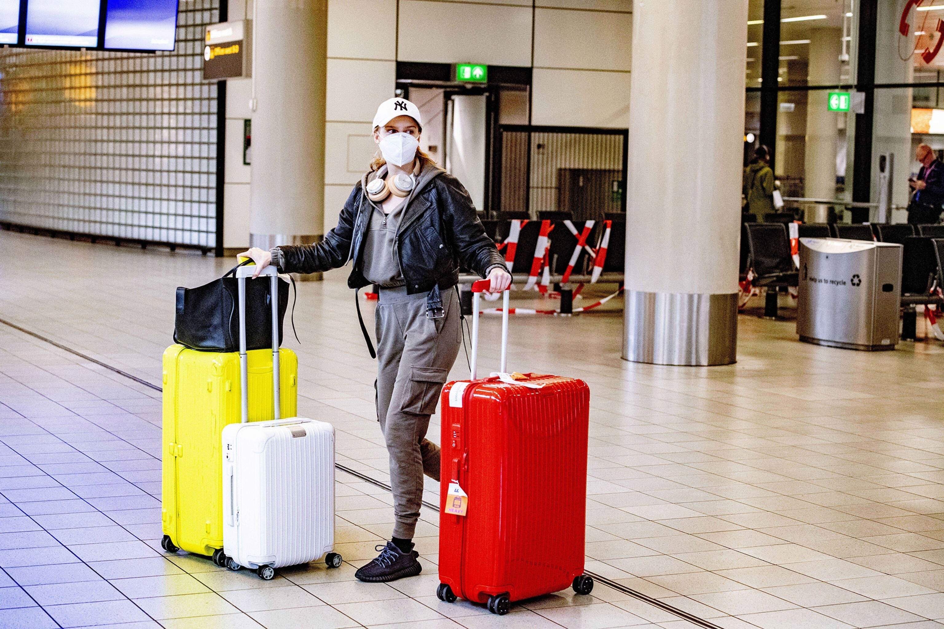 a traveler with a face mask at an airport